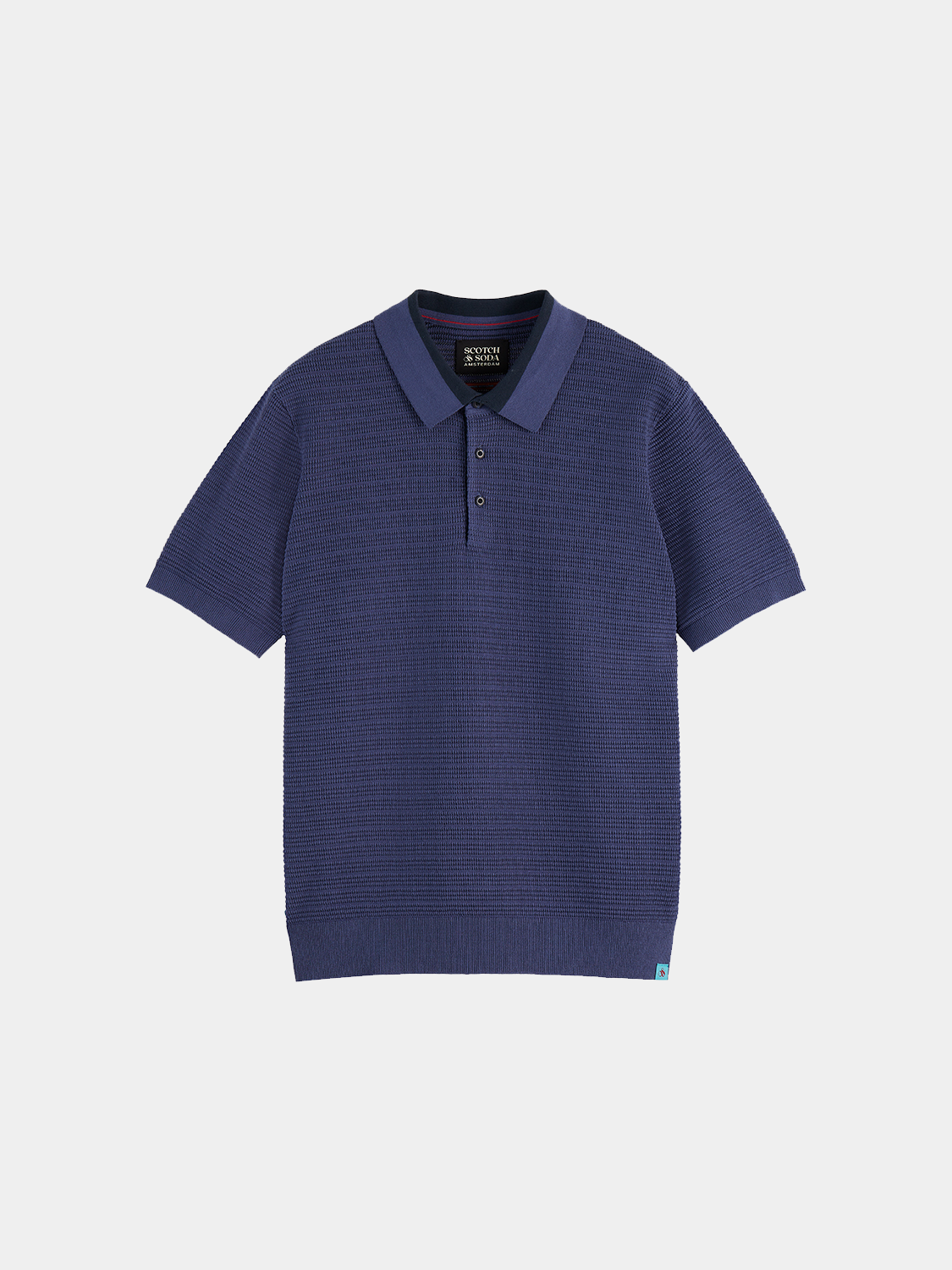 Structured knit polo shirt by Scotch & Soda featuring a classic collar and textured fabric, displayed on a neutral background.