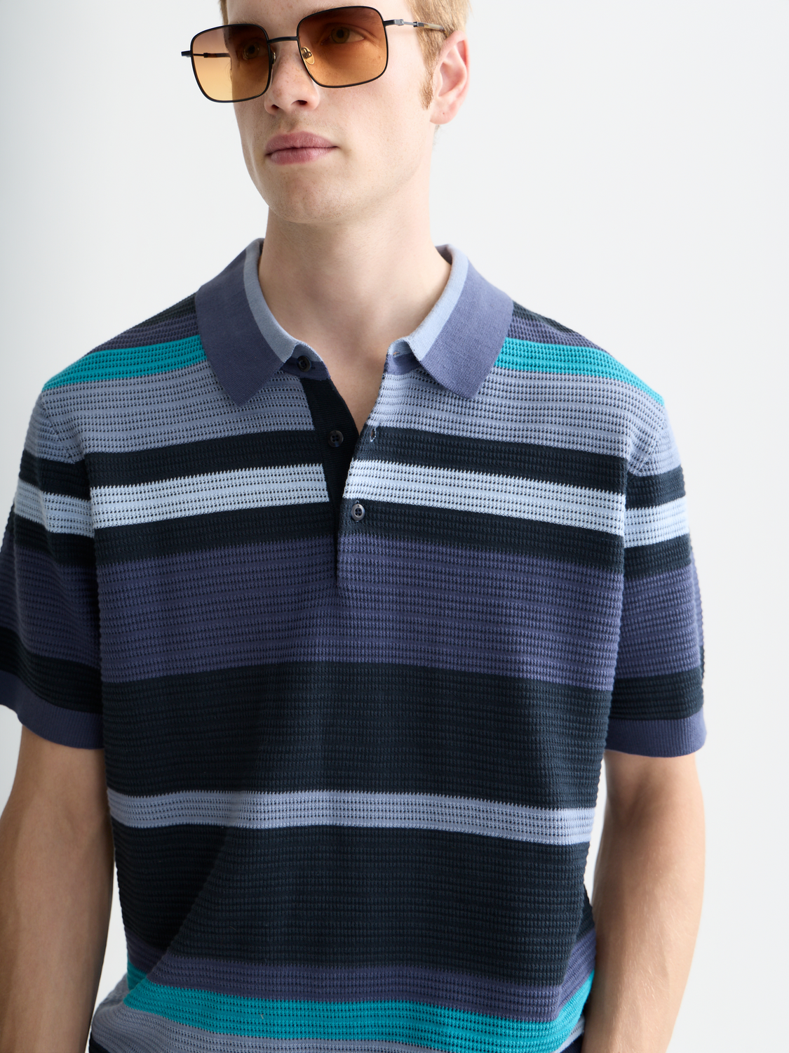 Scotch & Soda knitted polo shirt with a classic collar and textured knit fabric, displayed on a plain background.