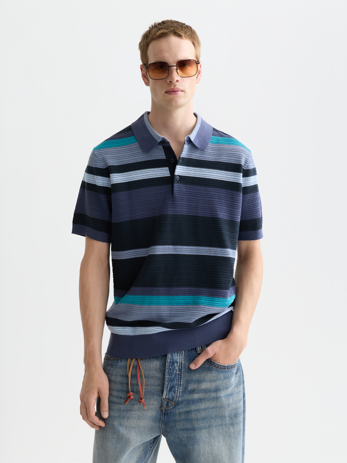 Scotch & Soda knitted polo shirt in navy with a ribbed collar and button placket, displayed on a mannequin.