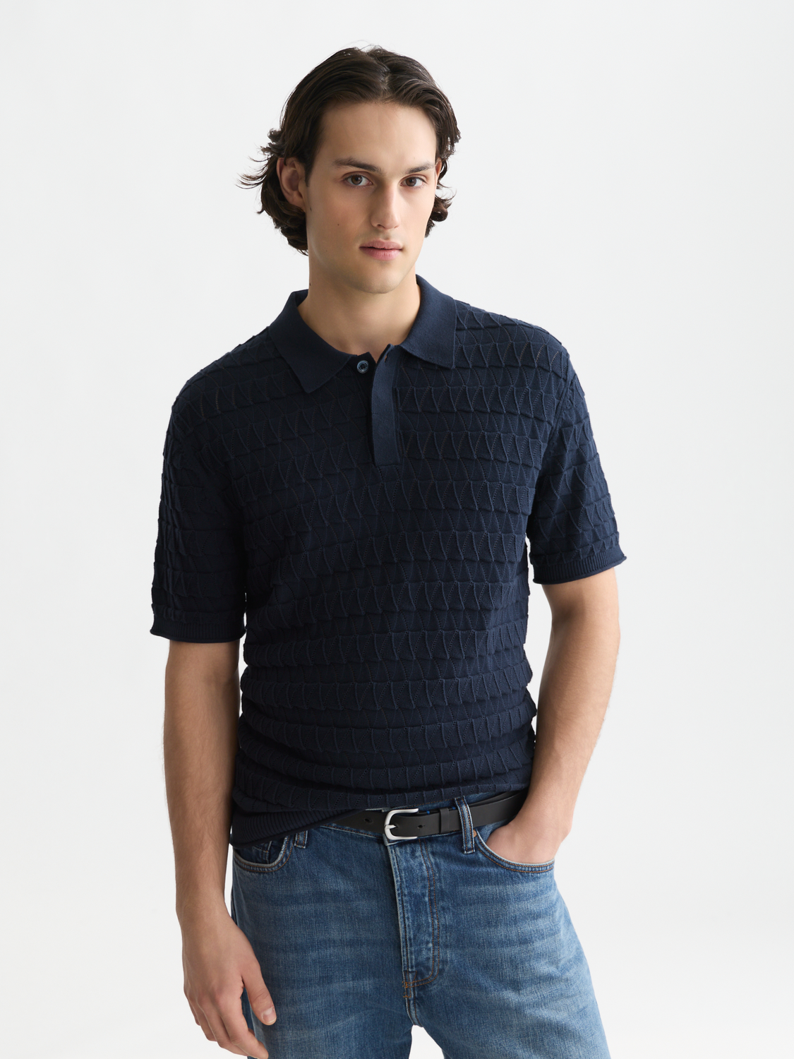 Knitted polo shirt by Scotch & Soda featuring a classic collar and textured knit fabric, displayed in a front view.