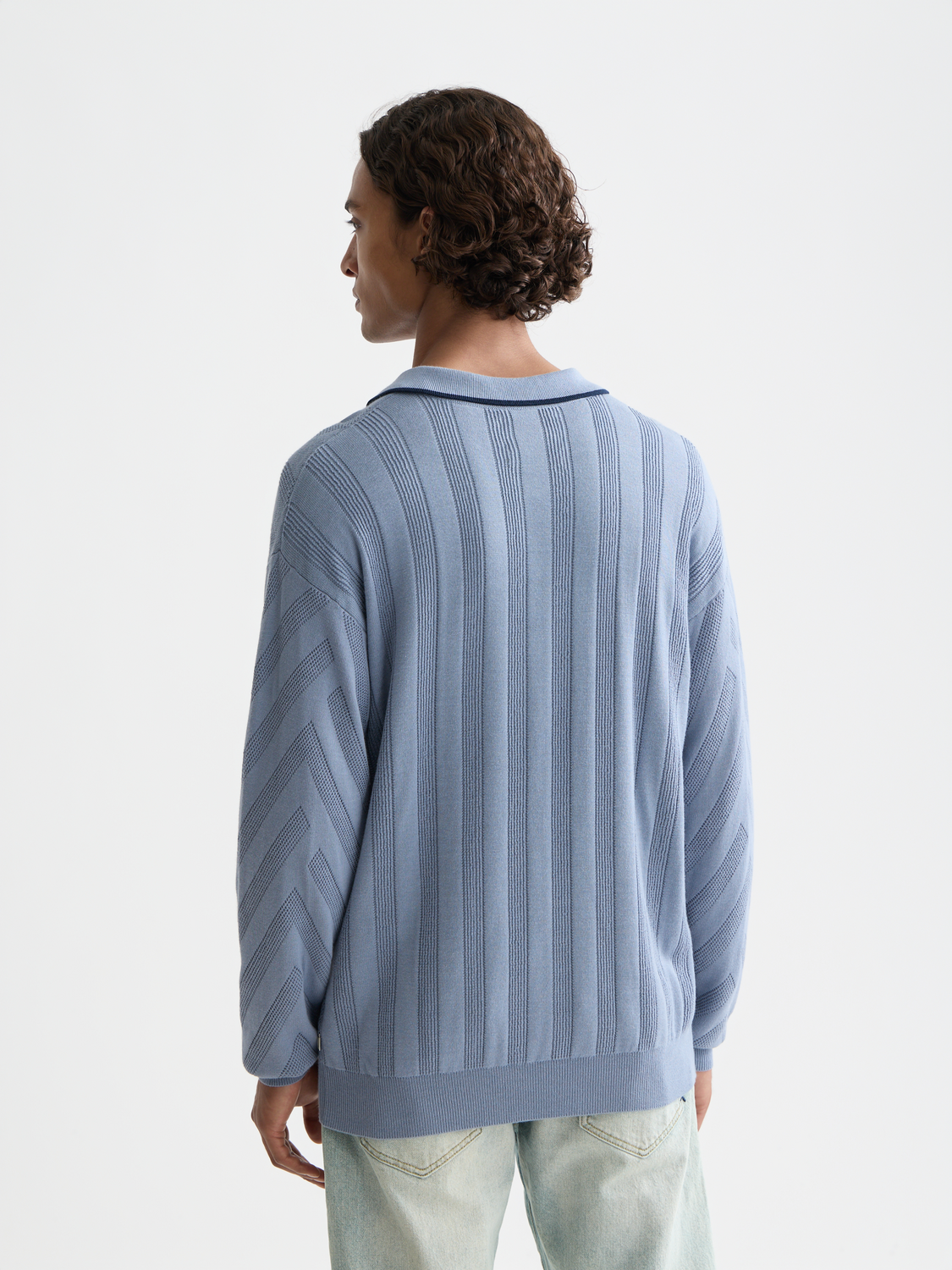 Long-sleeved Scotch & Soda polo shirt in dark blue with a collar, shown from the back with visible stitching and fabric texture.