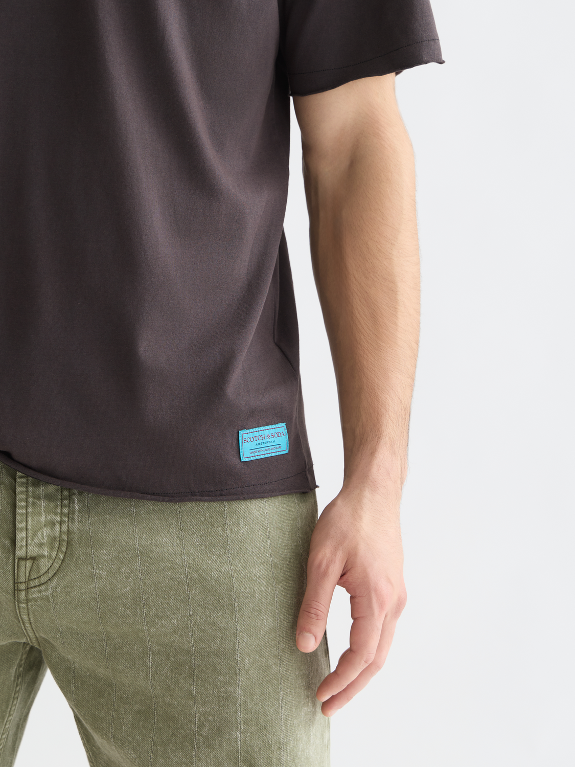 Raw edge Scotch & Soda short sleeve t-shirt with distressed hem and casual fit, shown in a neutral color.