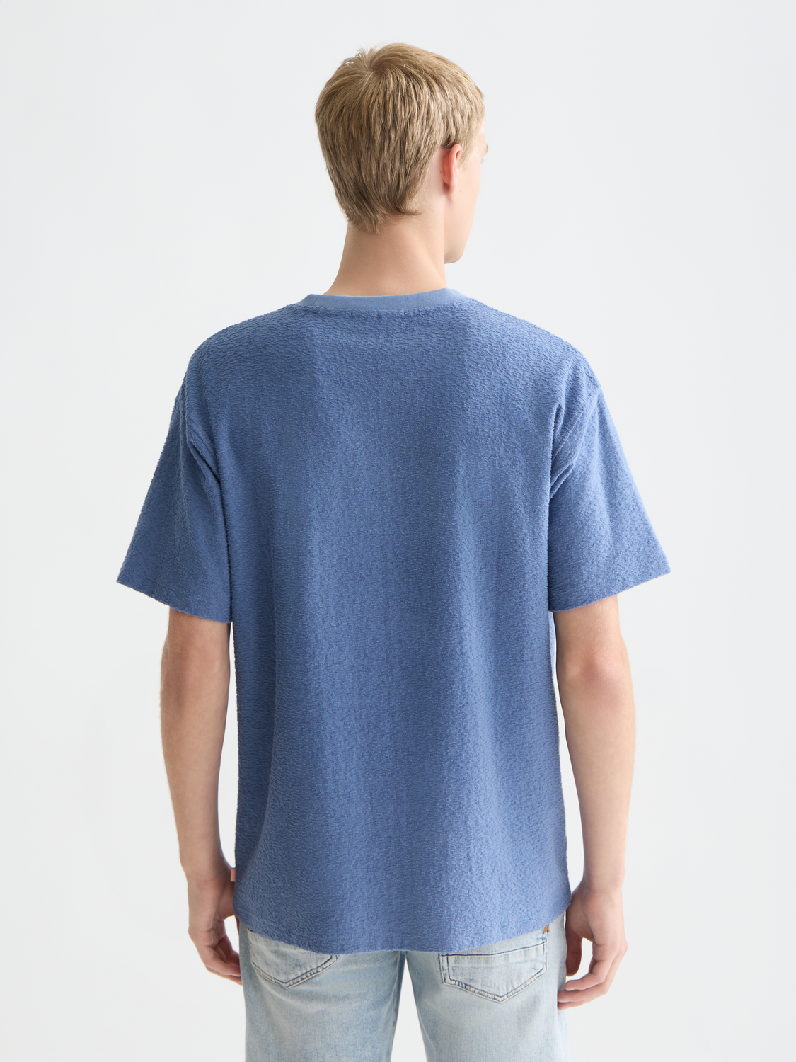 Black Scotch & Soda jacquard towelling short-sleeve t-shirt displayed on a model, showcasing textured fabric and modern fit.