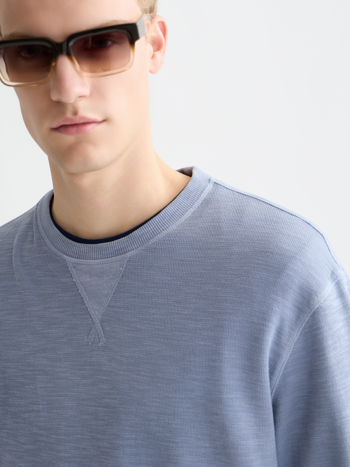 Garment-dyed sweatshirt by Scotch & Soda, featuring a relaxed fit with soft fabric and casual style, shown in a close-up view.