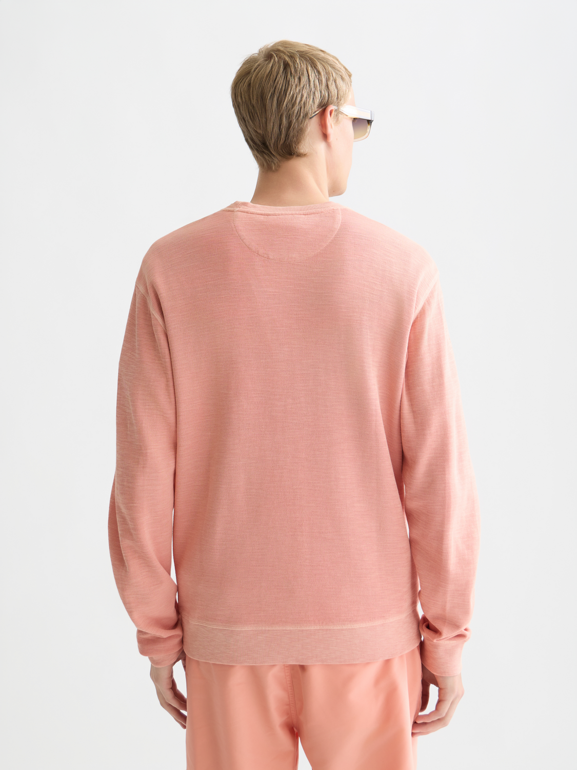 Garment-dyed sweatshirt from Scotch & Soda in a relaxed fit, showing the back view with soft fabric and casual style.