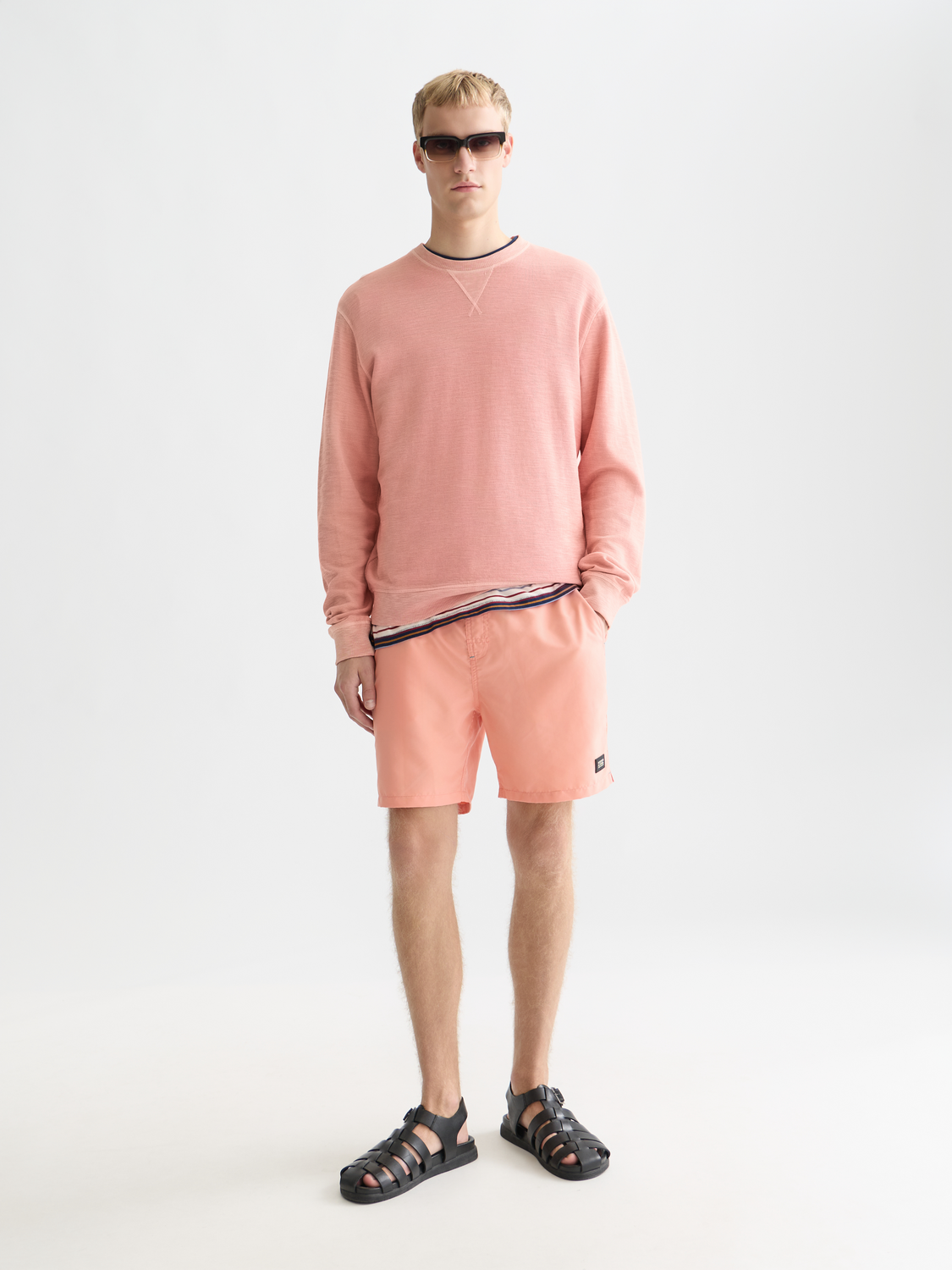 Gray garment-dyed sweatshirt from Scotch & Soda with a relaxed fit and soft fabric, shown on a model.