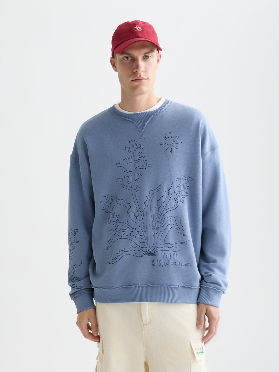 Embroidered sweatshirt by Scotch & Soda with colorful floral embroidery on navy sweats, front view showing detailed design.