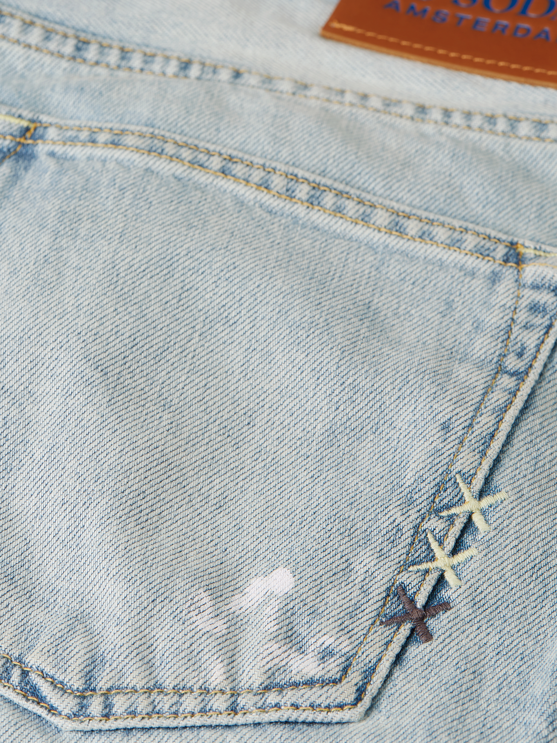SCOTCH & SODA wide-fit denim jeans with a classic five-pocket design, displayed folded on a plain background.