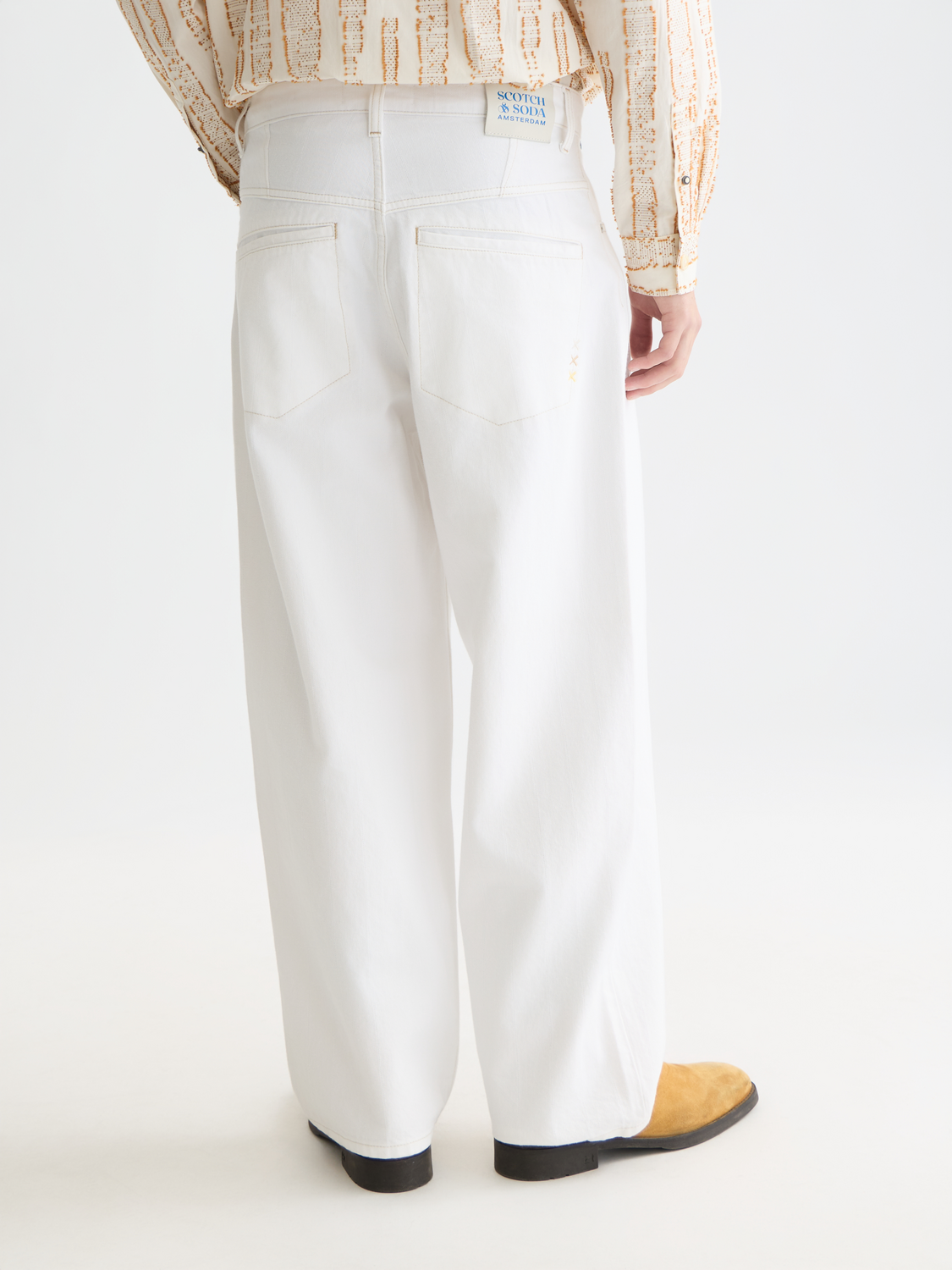 Back view of SCOTCH & SODA Daze loose-fit denim jeans showcasing relaxed fit and classic denim texture.