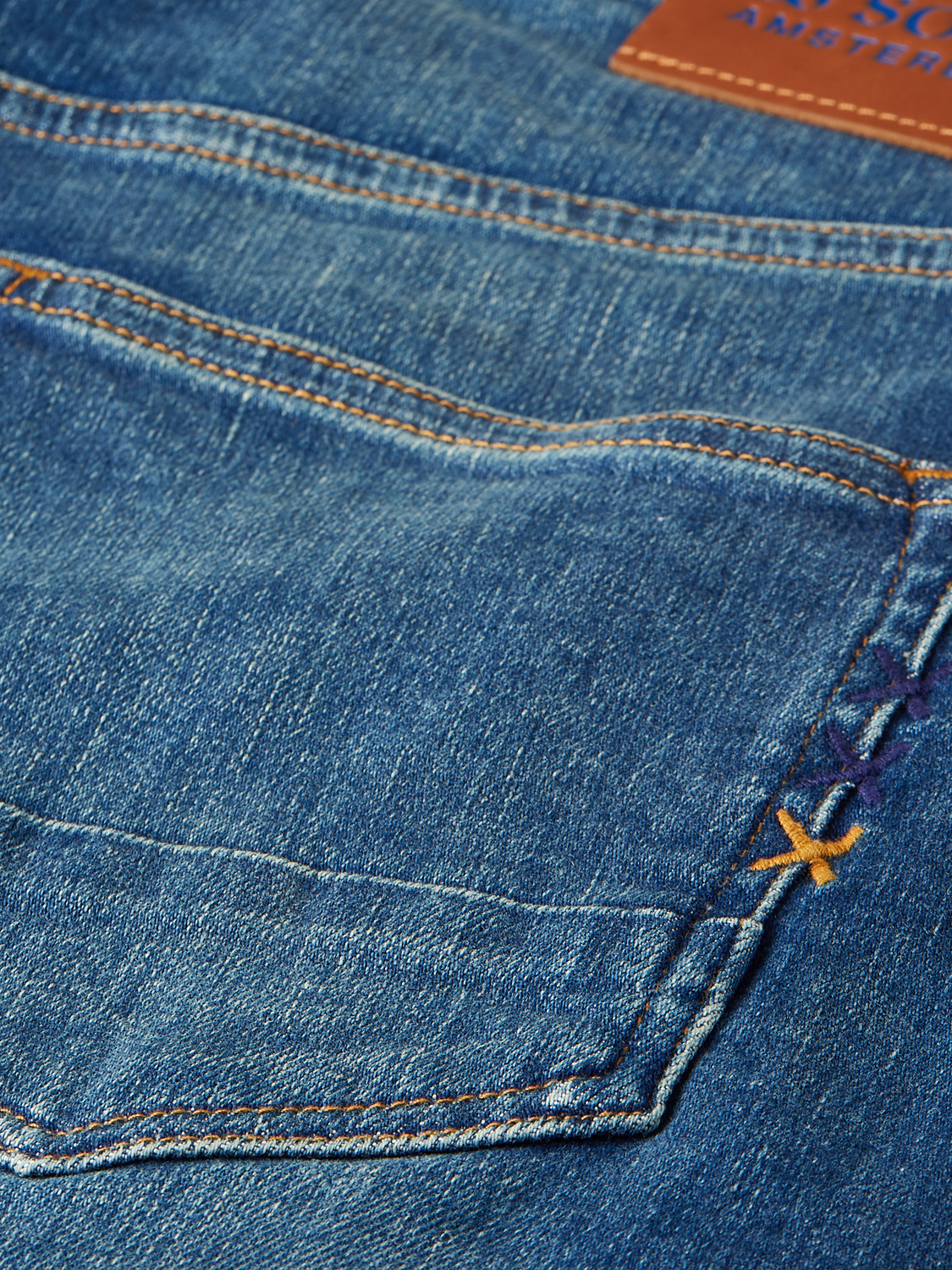 SCOTCH & SODA Ralston denim shorts with distressed finish, front pockets, and casual fit, shown on a model.