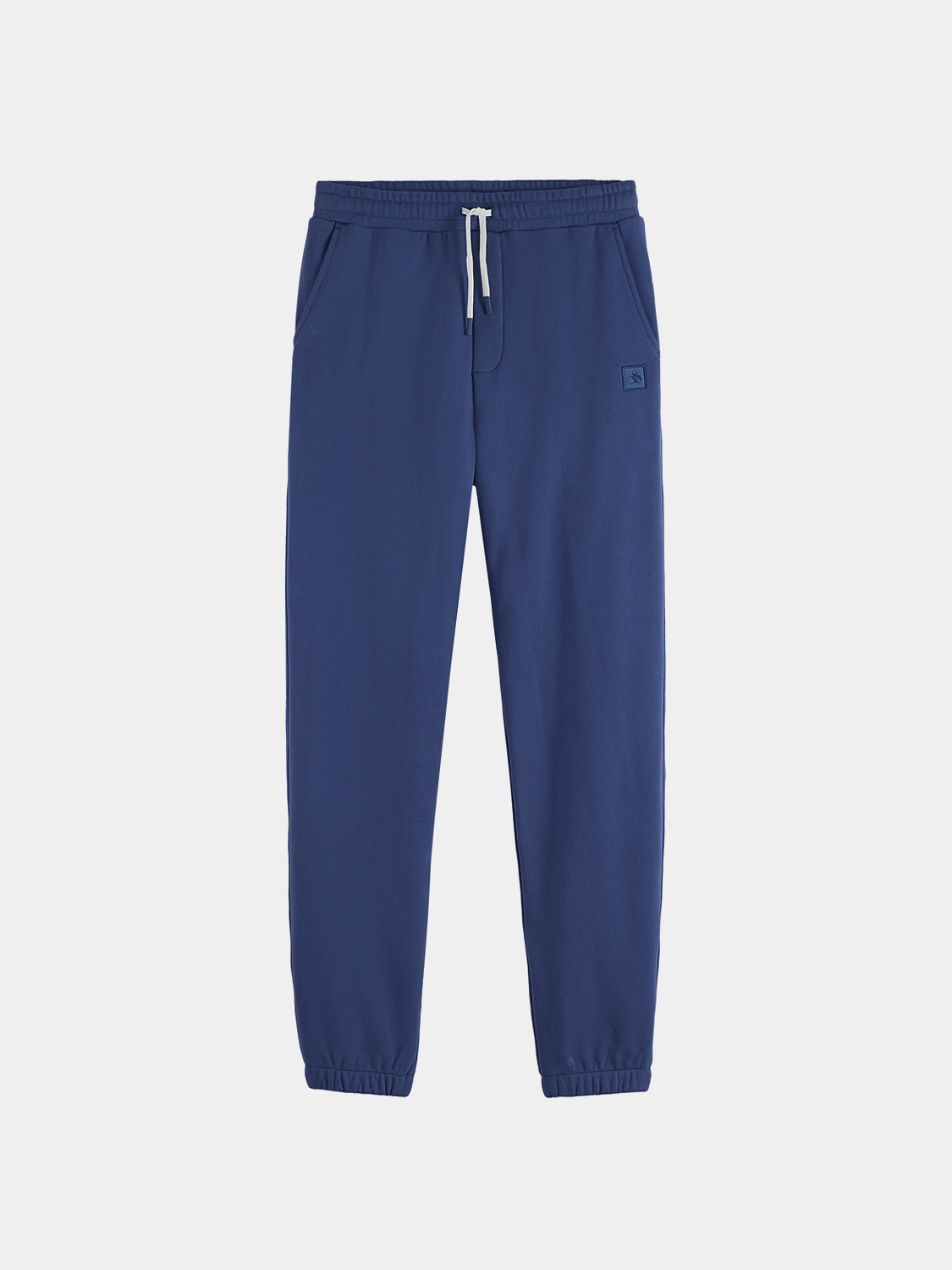 Black sweatpants with Scotch & Soda logo badge, casual athletic wear with elastic waistband and tapered fit.