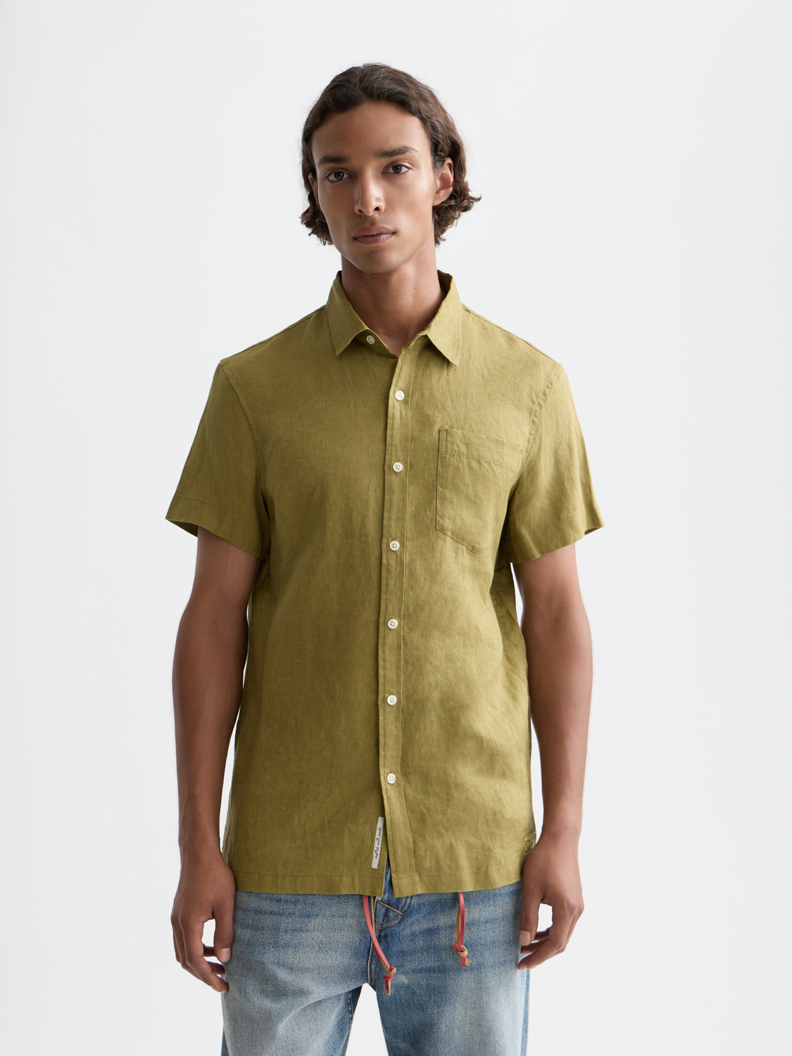 Short-sleeved linen shirt by Scotch & Soda, displayed on a hanger, featuring a lightweight, breathable fabric in a casual style.