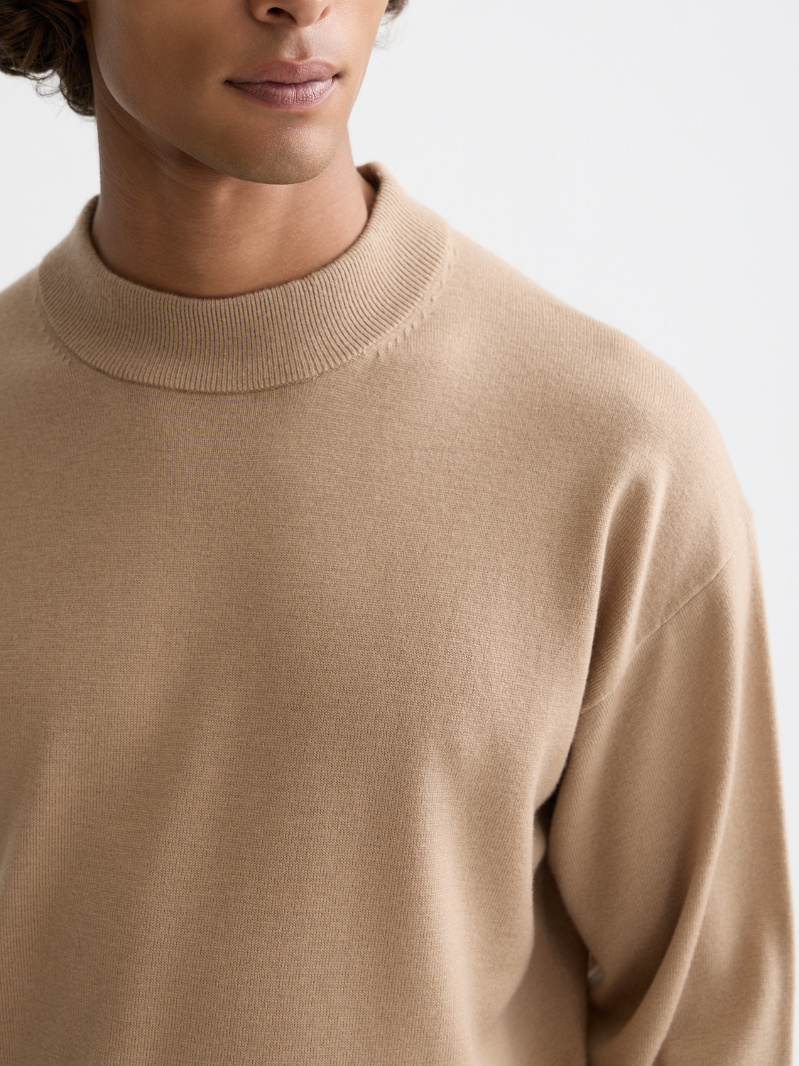Cream dropped shoulder mock neck knitwear by Scotch & Soda featuring a cozy, relaxed fit and ribbed detailing.