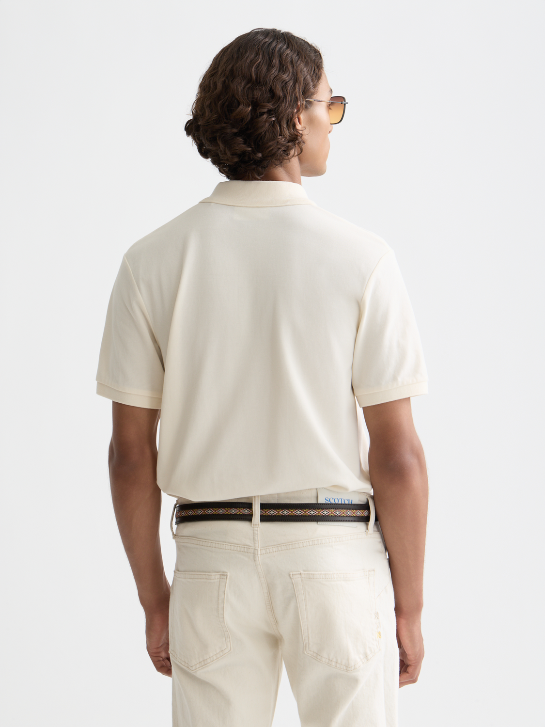 Navy Scotch & Soda logo pique polo shirt with a collared neckline and short sleeves, displayed on a mannequin.