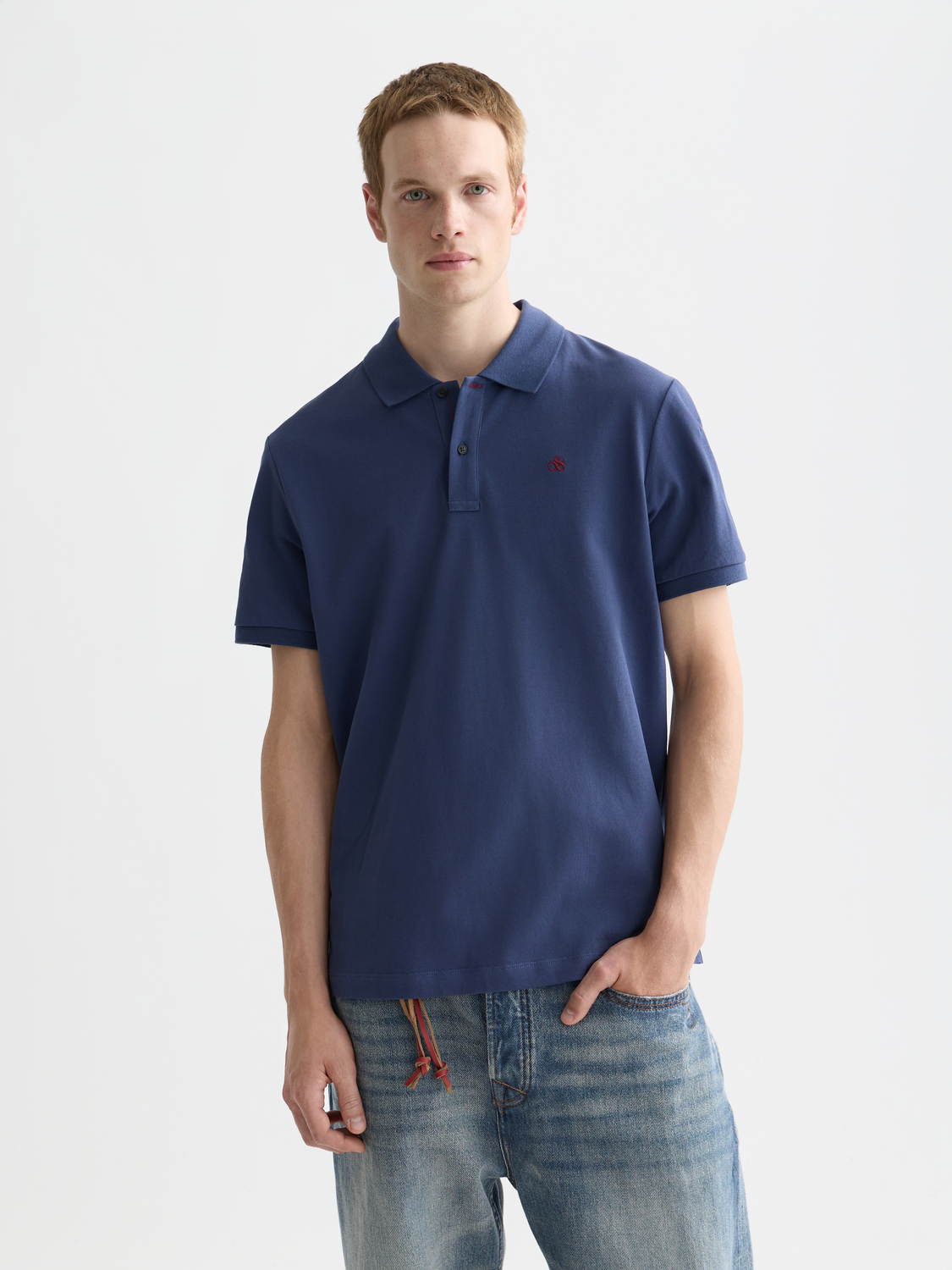 Scotch & Soda logo pique polo shirt in navy with classic collar and short sleeves, displayed on a white background.