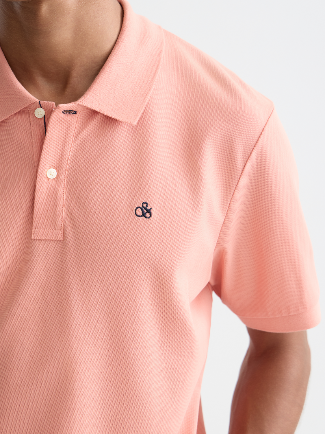 Navy Scotch & Soda logo pique polo shirt with a classic collar and short sleeves, displayed on a plain background.