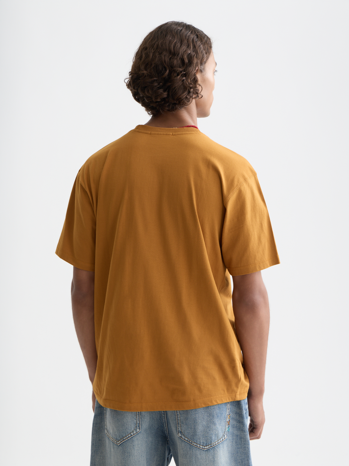 Short-sleeve Scotch & Soda logo t-shirt with front graphic, shown from the back on a plain background.