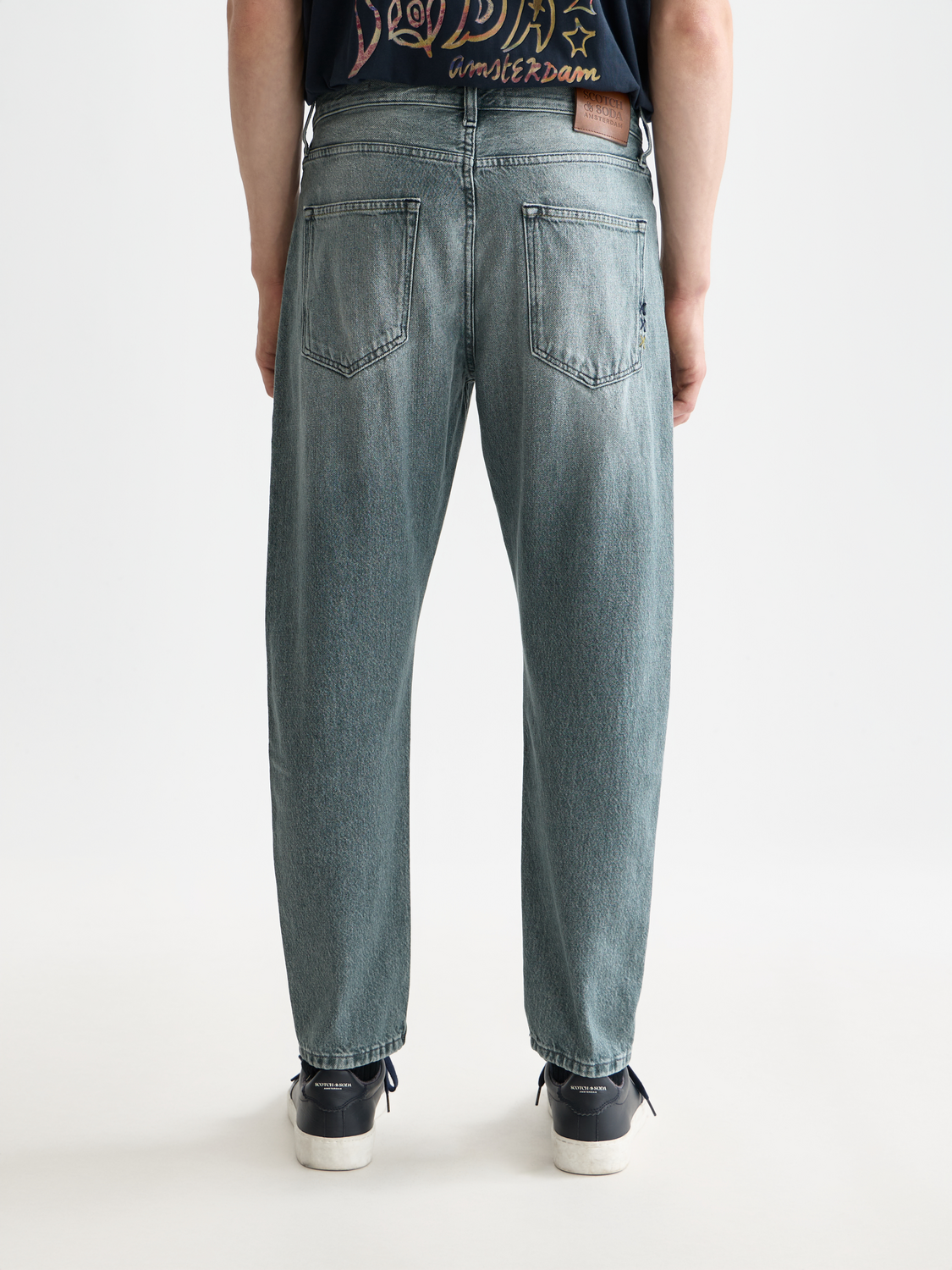 Back view of SCOTCH & SODA Dean tapered denim jeans showing dark wash, tapered fit, and classic five-pocket design.