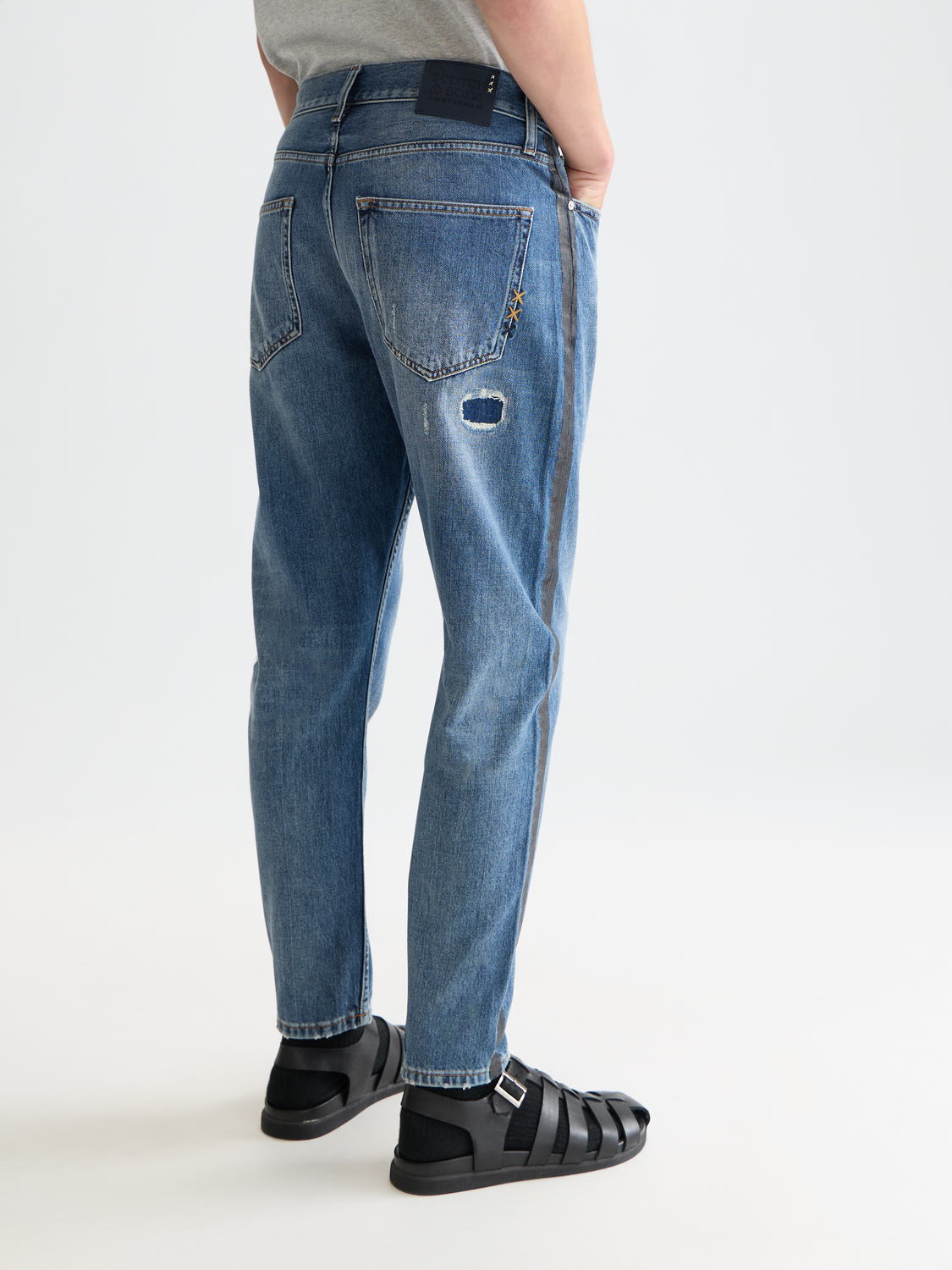 Back view of Scotch & Soda Dean tapered denim jeans showing dark wash, slim fit, and classic five-pocket design.