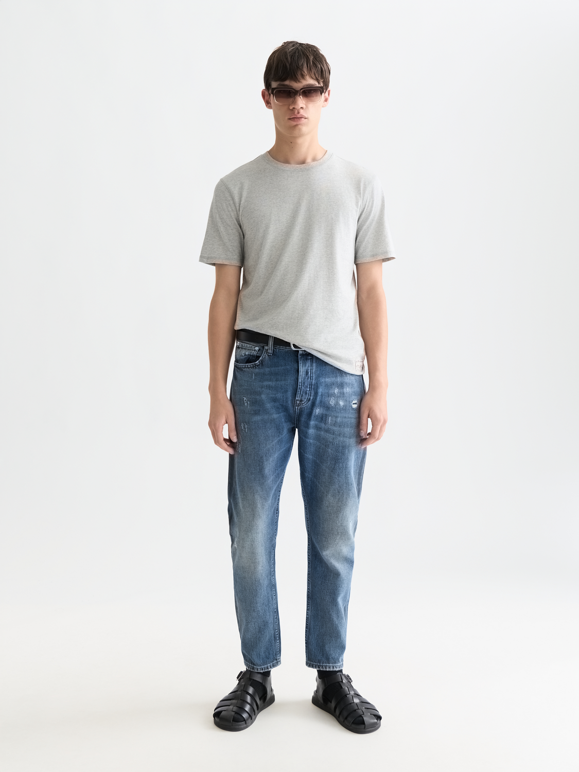Scotch & Soda Dean tapered denim jeans showing slim fit design and classic blue wash fabric, front view.