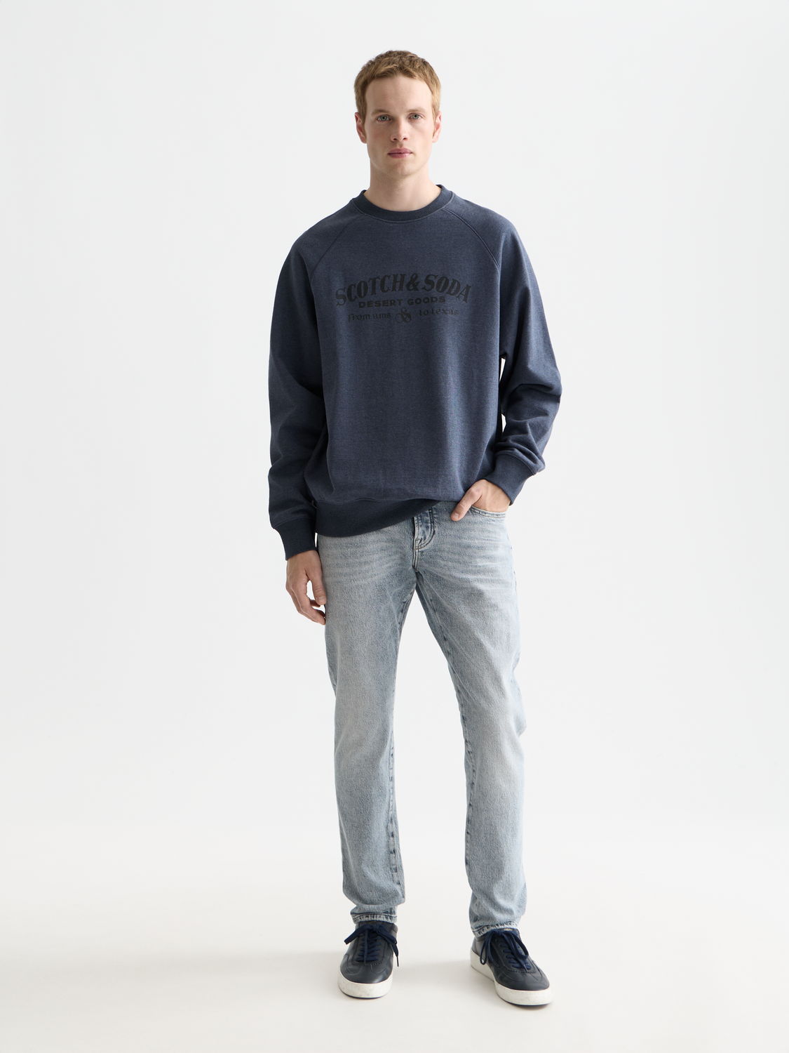 Slim-fit Scotch & Soda Ralston denim jeans displayed on a model, showcasing modern style and classic blue color.