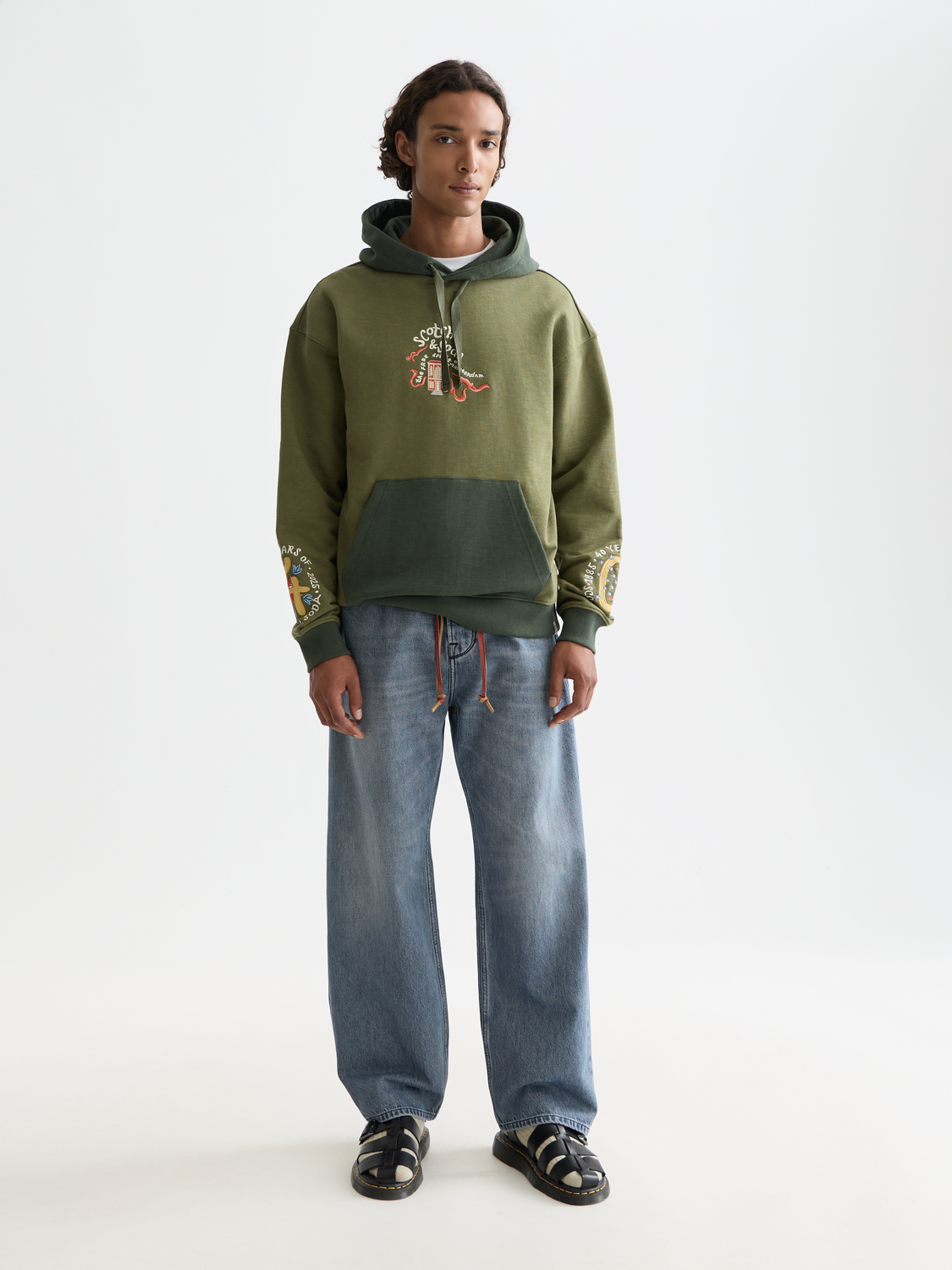 Embroidered hoodie from Scotch & Soda, featuring detailed stitching and a comfortable fit, showcased on a model.
