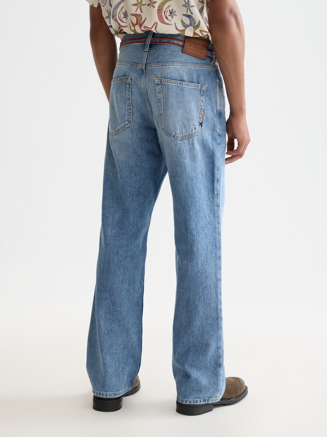 Wide-fit denim jeans by Scotch & Soda, featuring a relaxed fit and classic denim wash, shown from the back with pockets and stitching details.