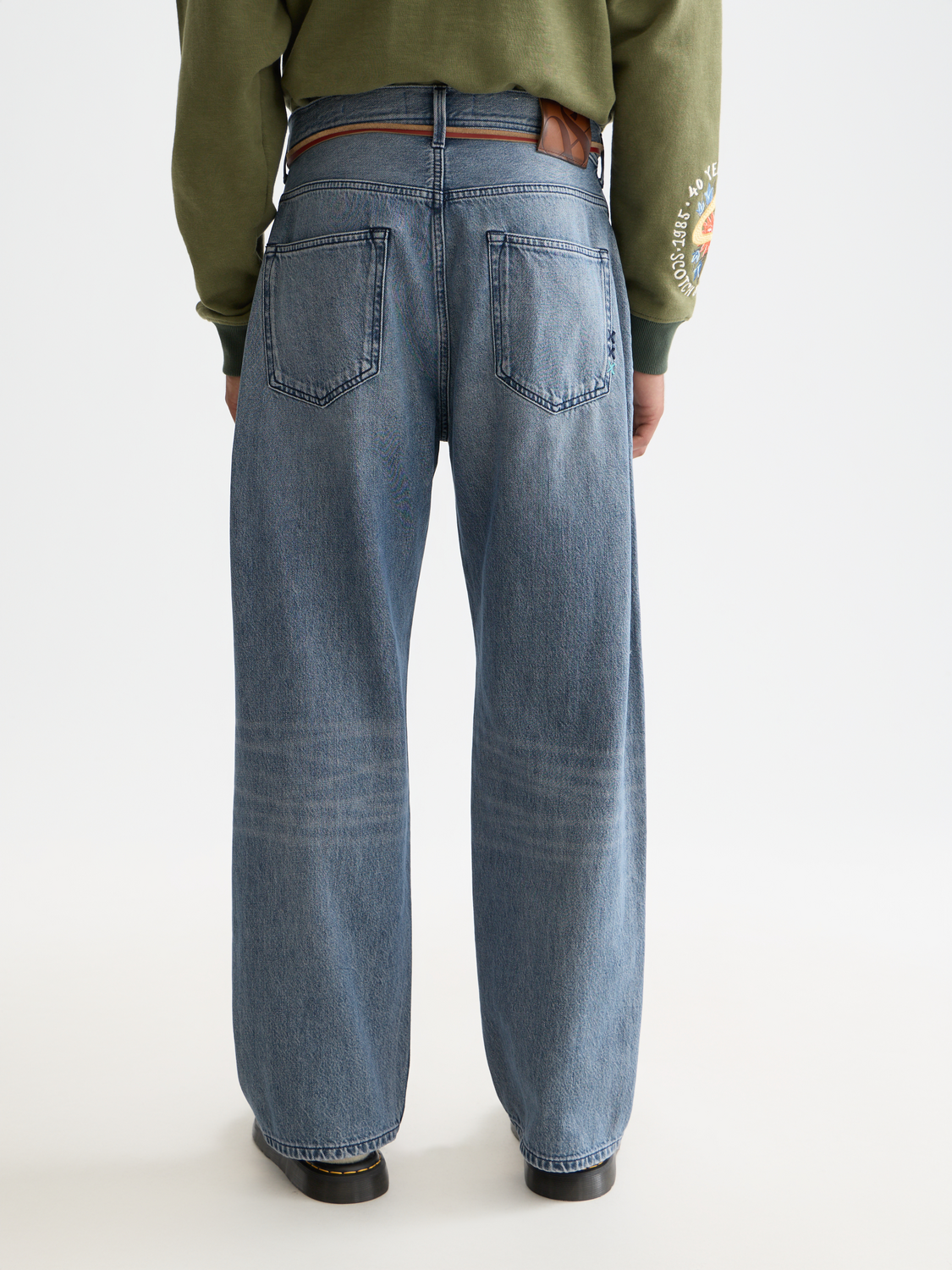 Loose-fit denim jeans by Scotch & Soda, showing back view with distressed details and classic five-pocket design.