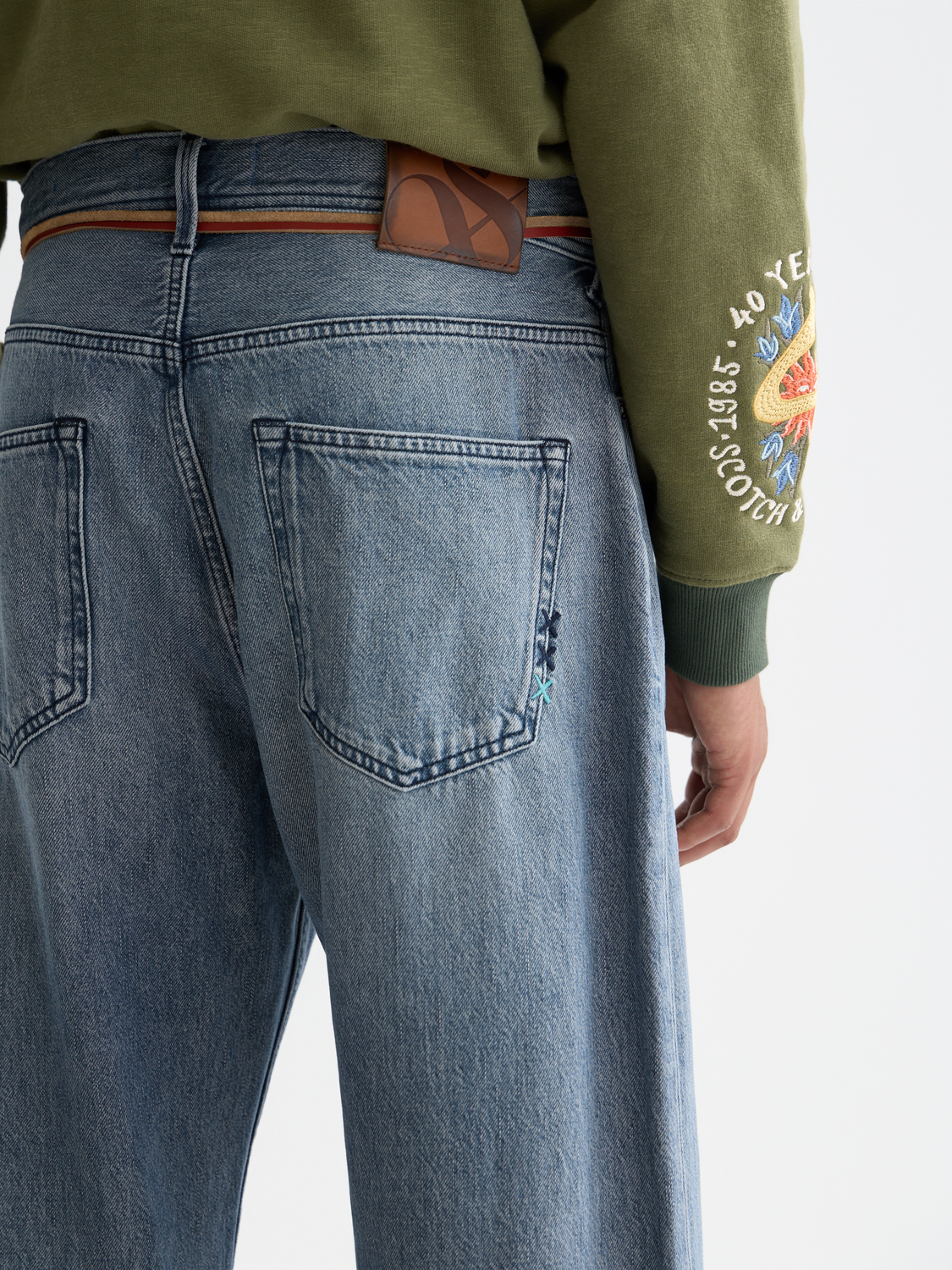 Loose-fit denim jeans by Scotch & Soda with a relaxed style, shown on a model demonstrating casual, trendy denim wear.