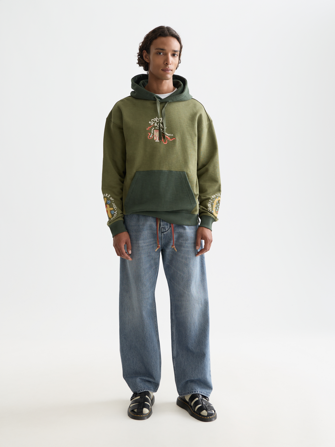 Scotch & Soda pitch loose-fit denim jeans with classic five-pocket design and faded blue wash, front view.