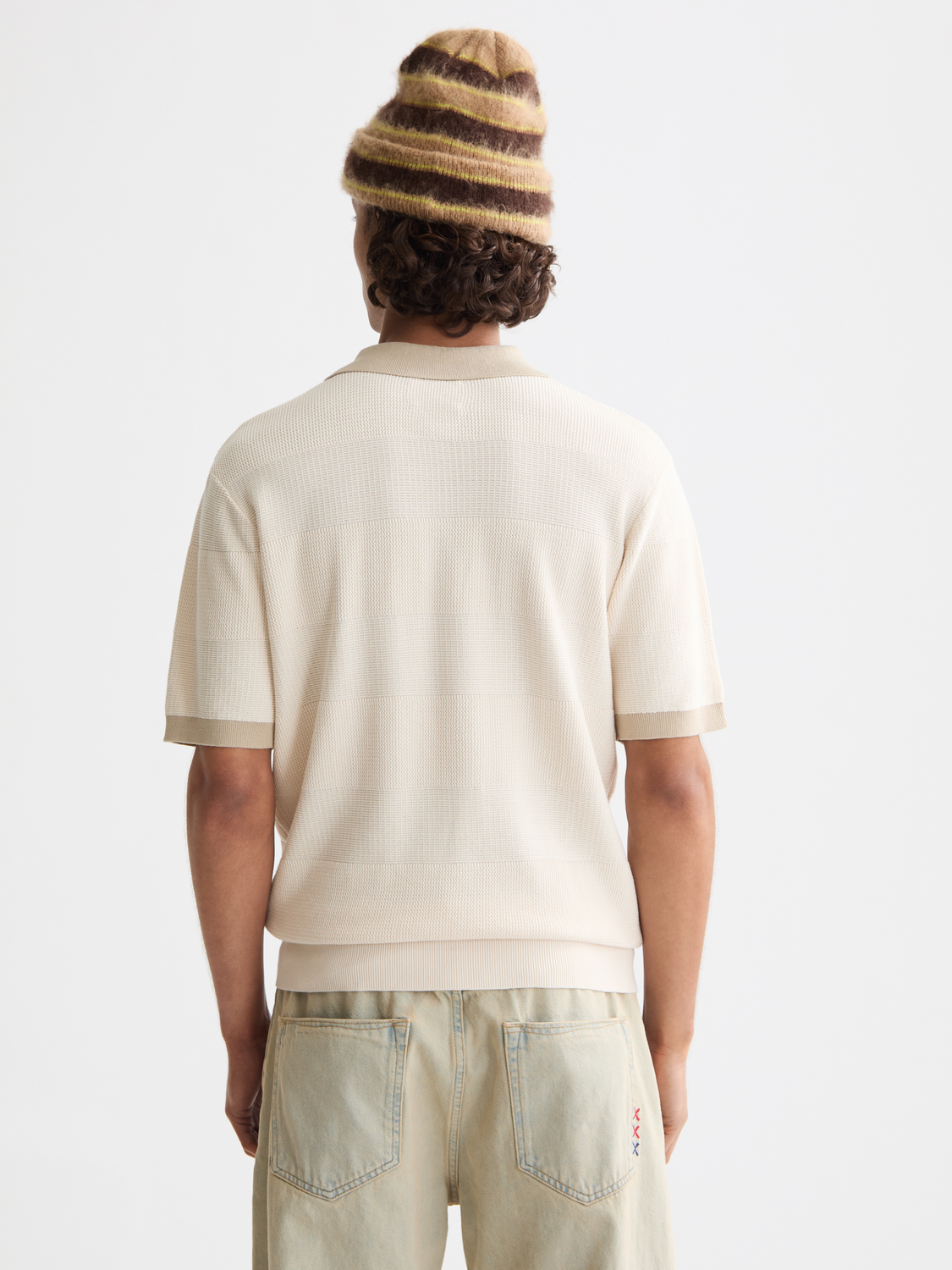 Knitted tonal polo shirt by Scotch & Soda, showing the back view with a textured fabric and classic collar design.