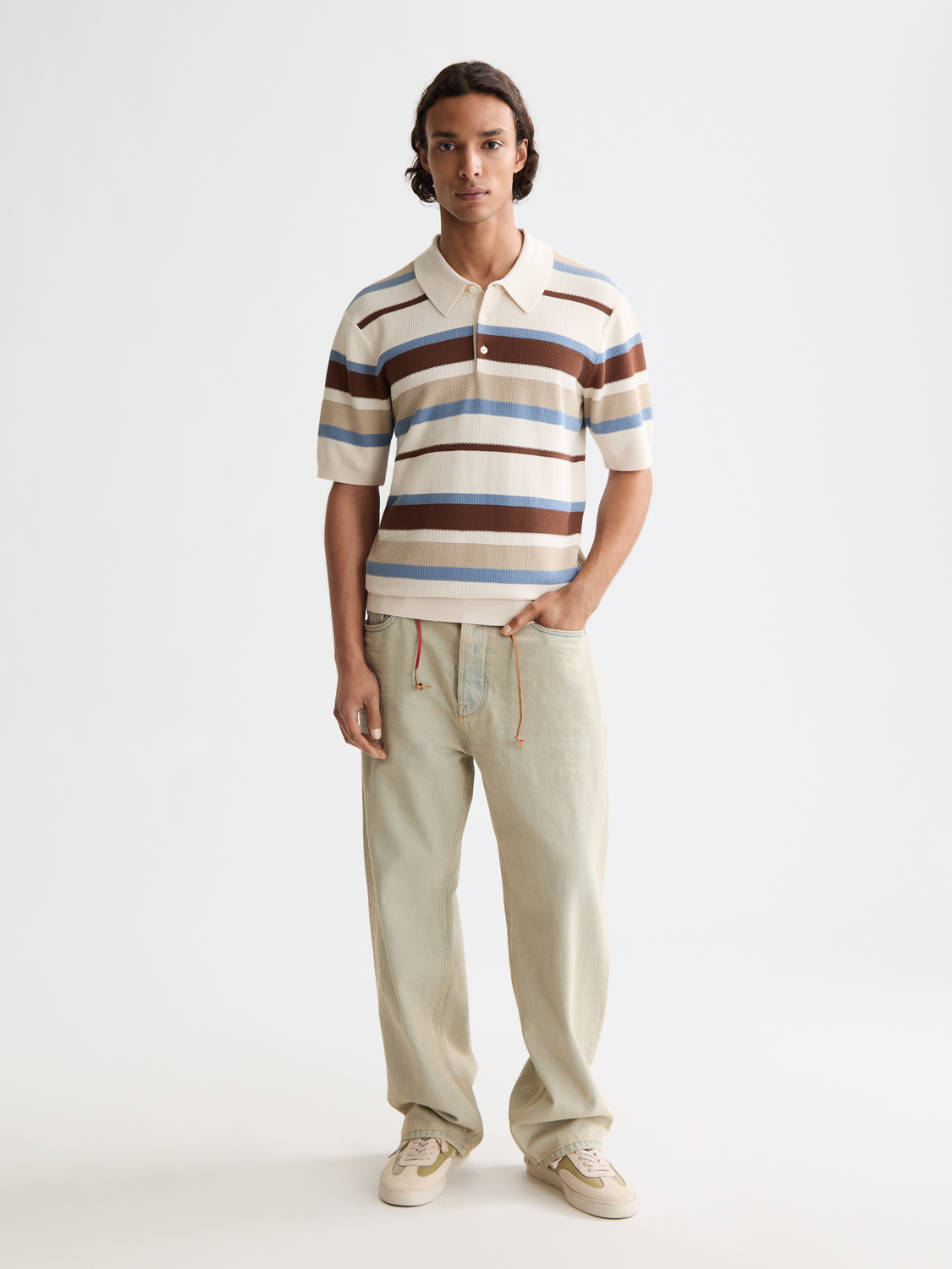 Knitted striped polo shirt by Scotch & Soda, featuring a classic collar and multicolor horizontal stripes.