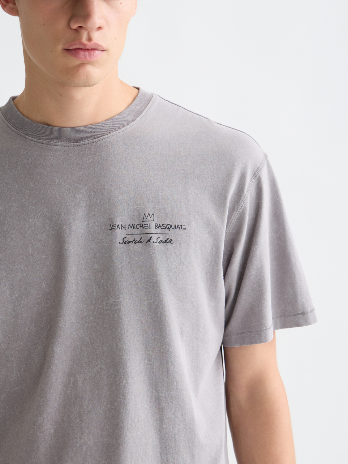 Short sleeve Scotch & SODA t-shirt featuring S&S x Basquiat artwork with vibrant graphic print on soft fabric.