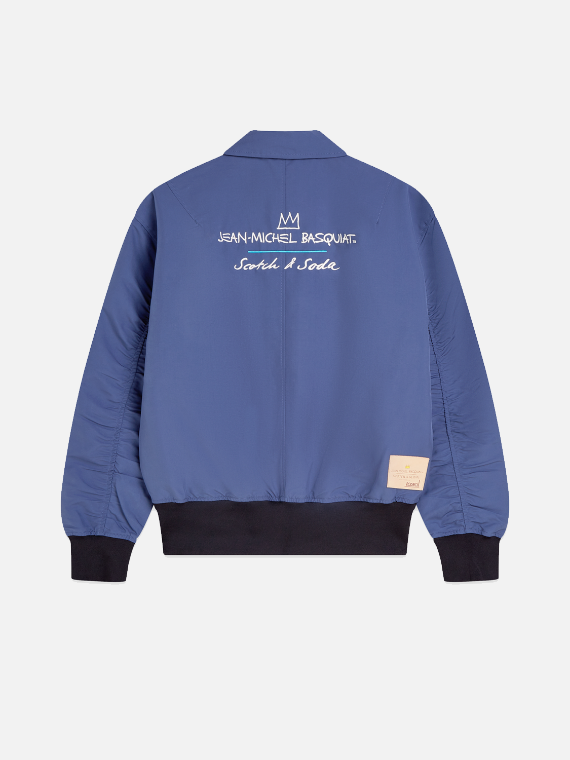Scotch & SODA S&S x Basquiat souvenir jacket with bold artwork and vibrant design, displayed on a hanger.