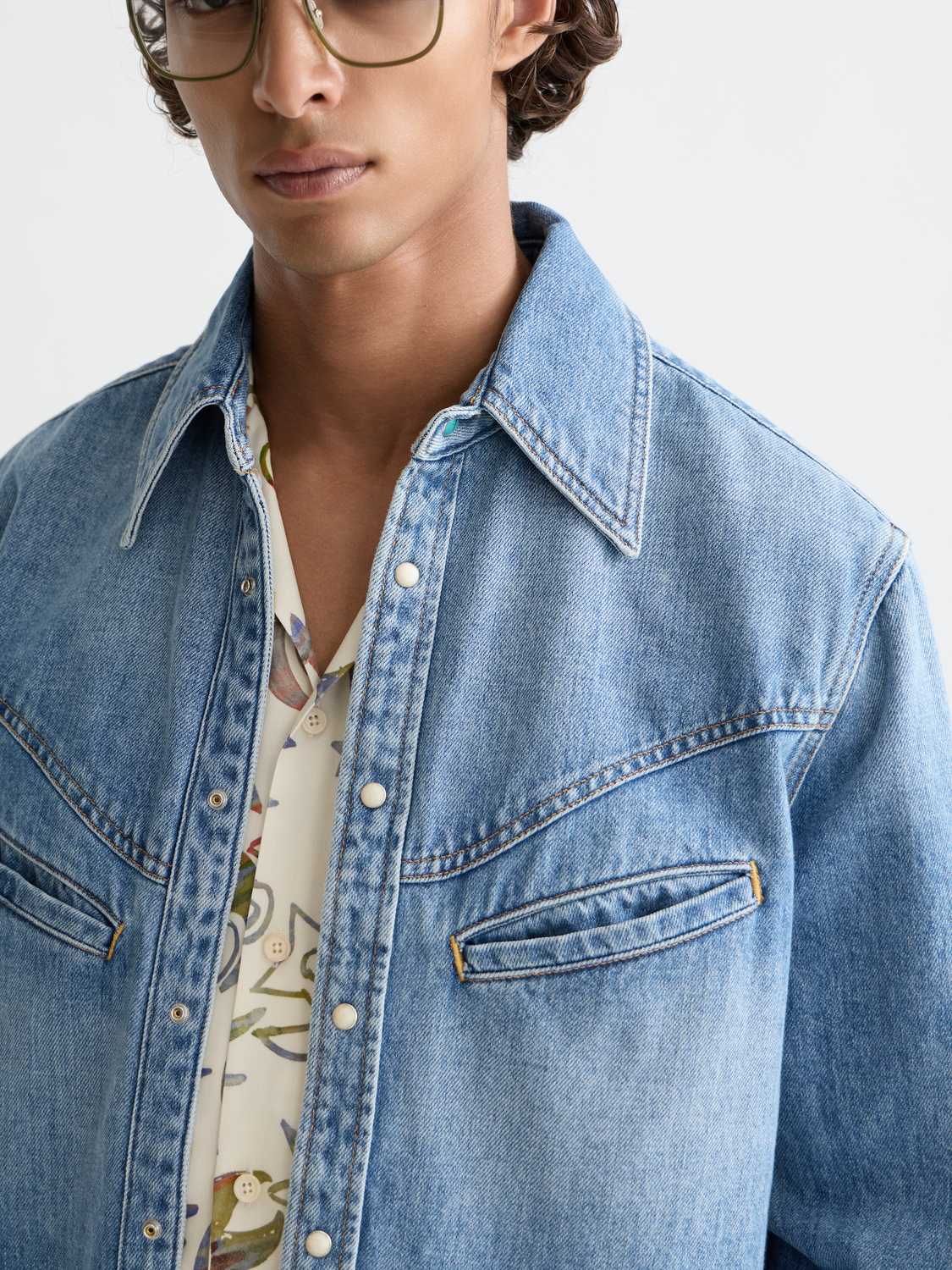 Long-sleeve washed denim shirt by Scotch & Soda, showing relaxed fit with classic collar and button front.