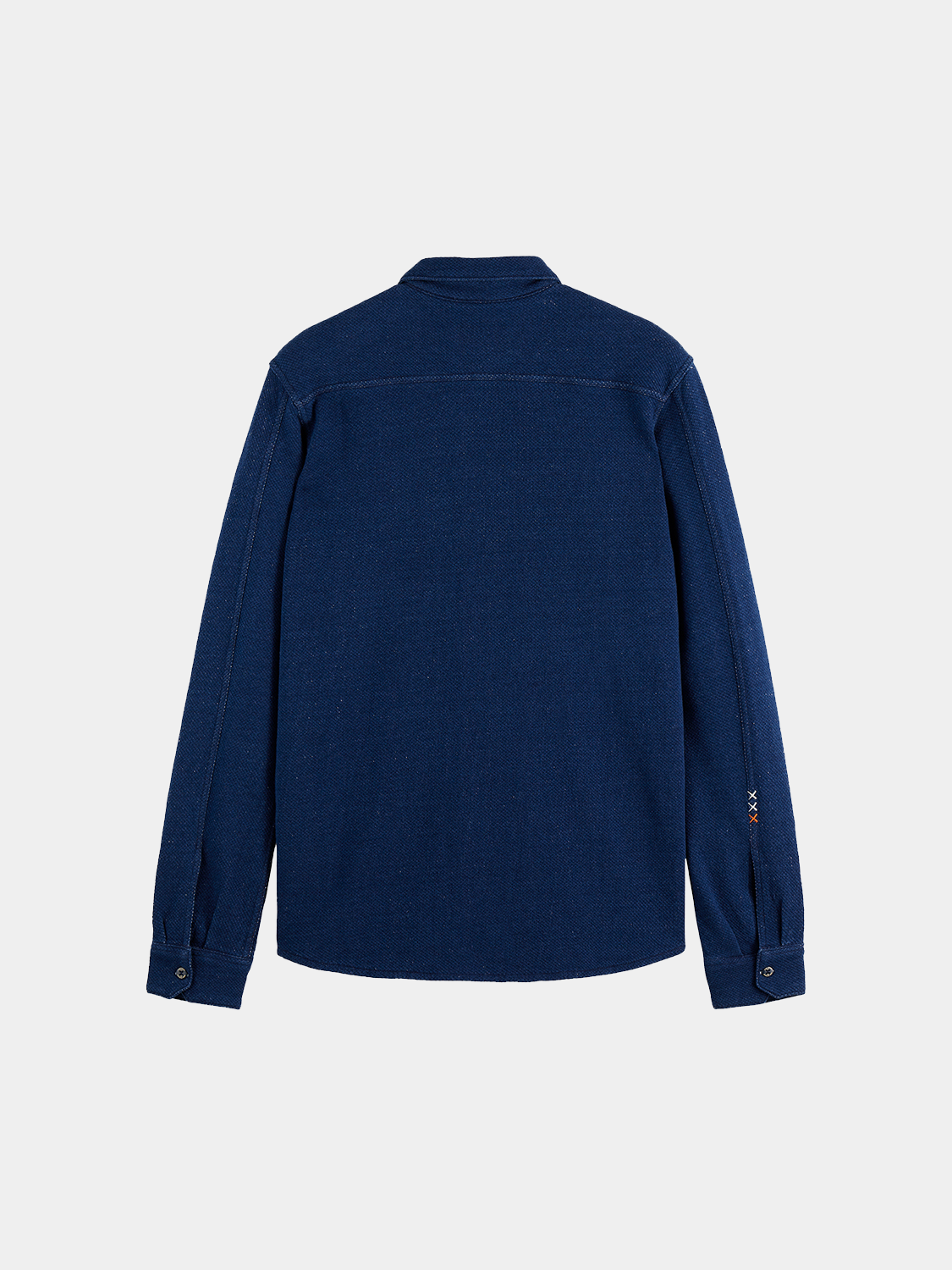 Washed indigo Scotch & Soda long-sleeve shirt with button-up front and classic collar, displayed on a hanger.