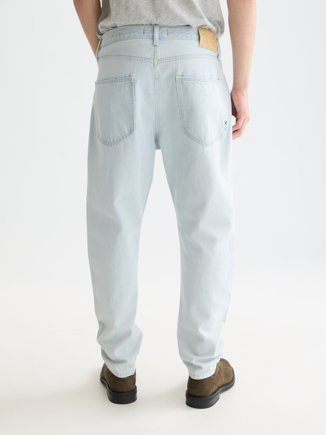 Dark blue Scotch & SODA Dean tapered denim jeans shown from the back, featuring classic stitching and a relaxed fit.
