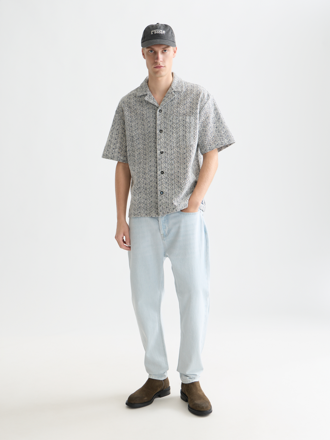 SCOTCH & SODA Dean tapered denim jeans shown in dark wash with subtle fading and classic five-pocket design.