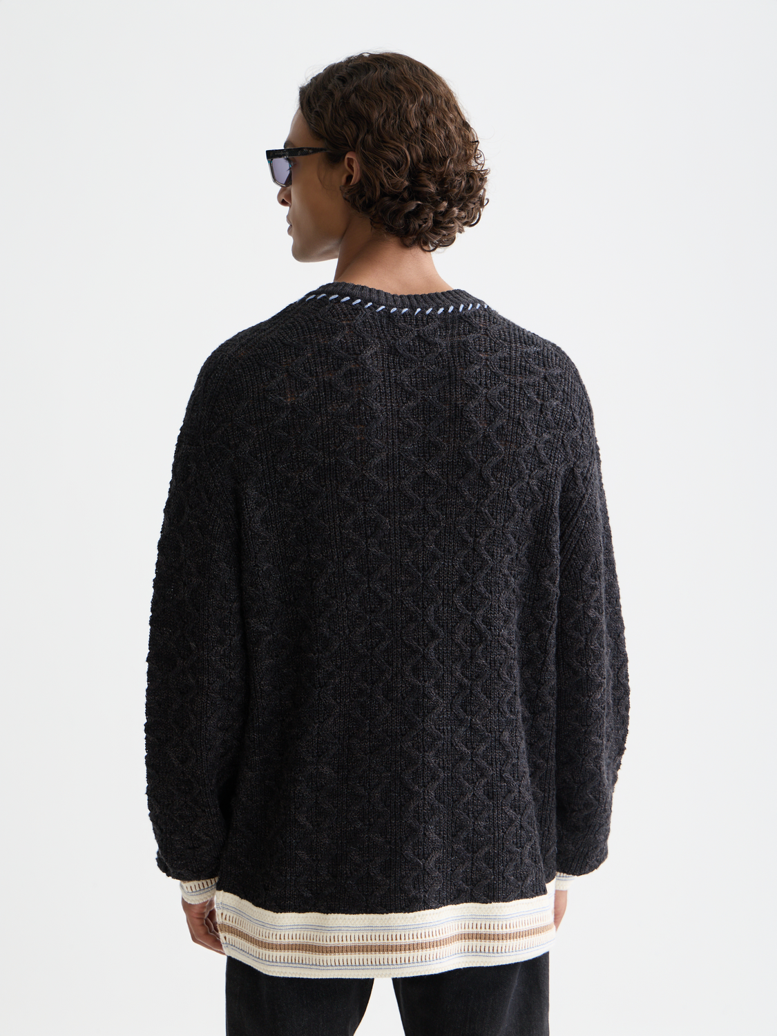 Scotch & Soda V-neck cable knit pullover in dark blue, showcasing its textured knit pattern and classic design.