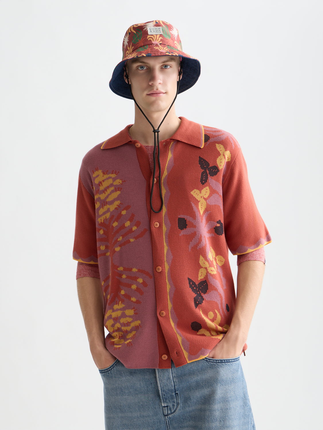 Knitted jacquard short-sleeved shirt by Scotch & Soda, featuring intricate knit patterns and a classic crew neck design.