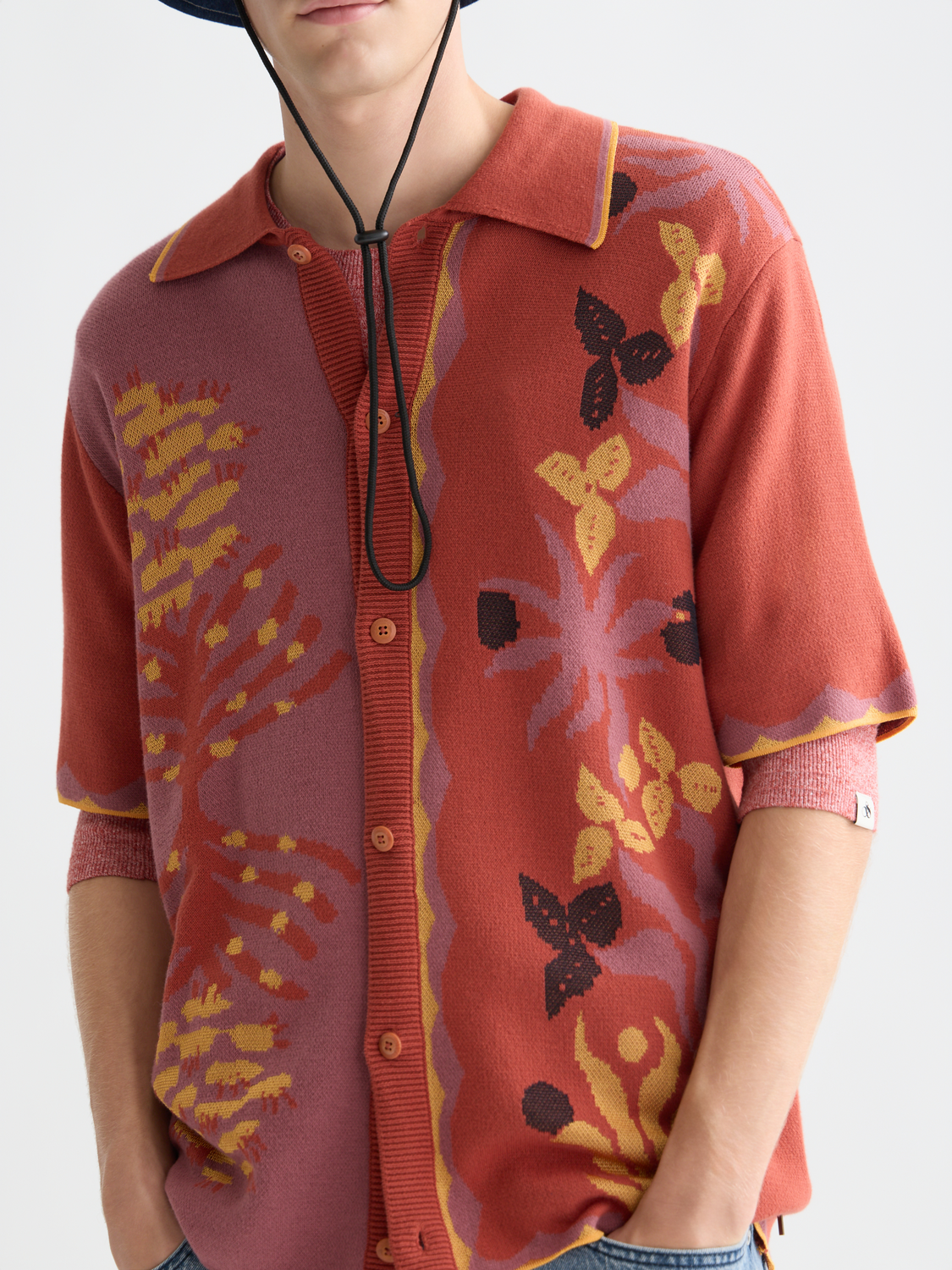 Knitted jacquard short-sleeved shirt by Scotch & Soda featuring intricate patterns and a classic fit, displayed on a white background.