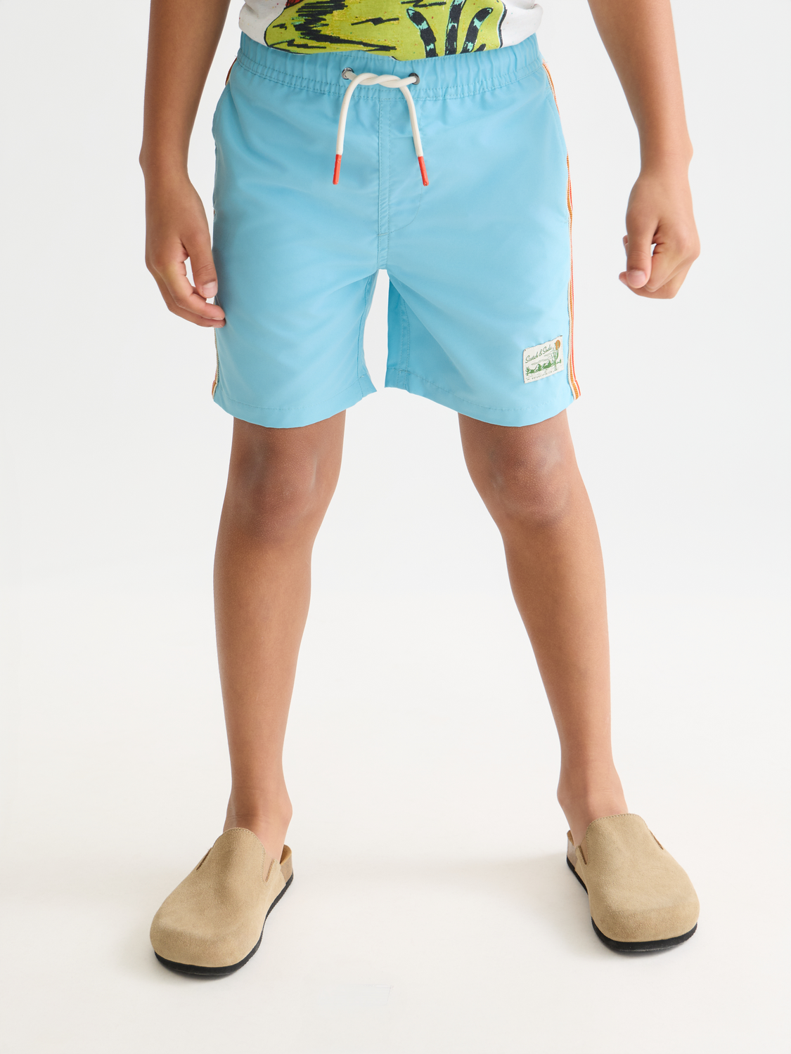Kids' Scotch & Soda printed swimshorts with colorful magic design, featuring elastic waistband and lightweight fabric for swimming.