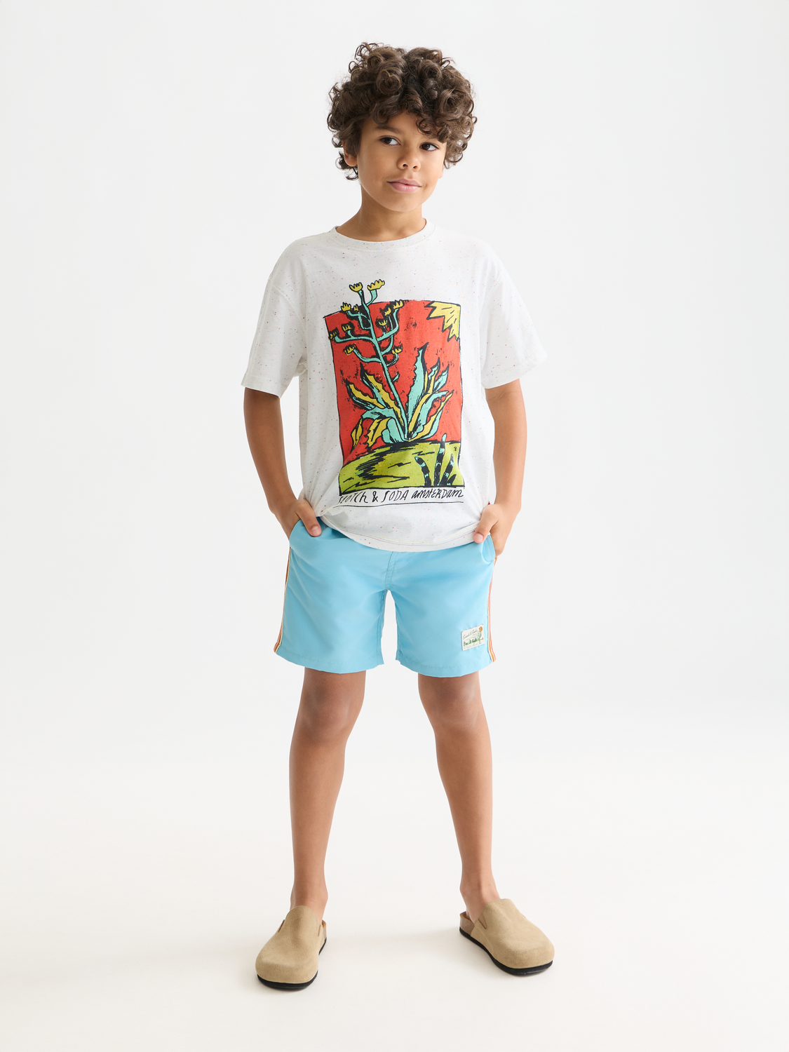 Kids' magic printed swimshorts by Scotch & Soda featuring colorful, playful swimwear design with elastic waistband and fun print.