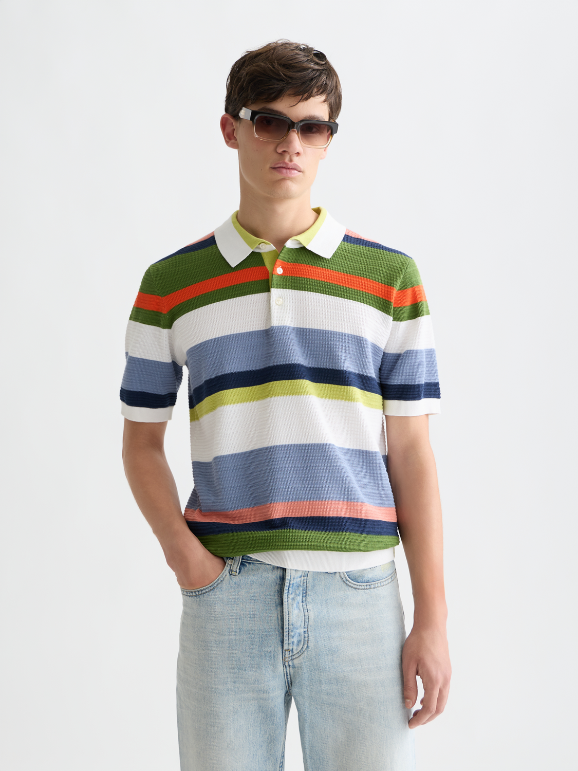 Knitted striped polo shirt by Scotch & Soda featuring a classic collar and multicolor horizontal stripes.