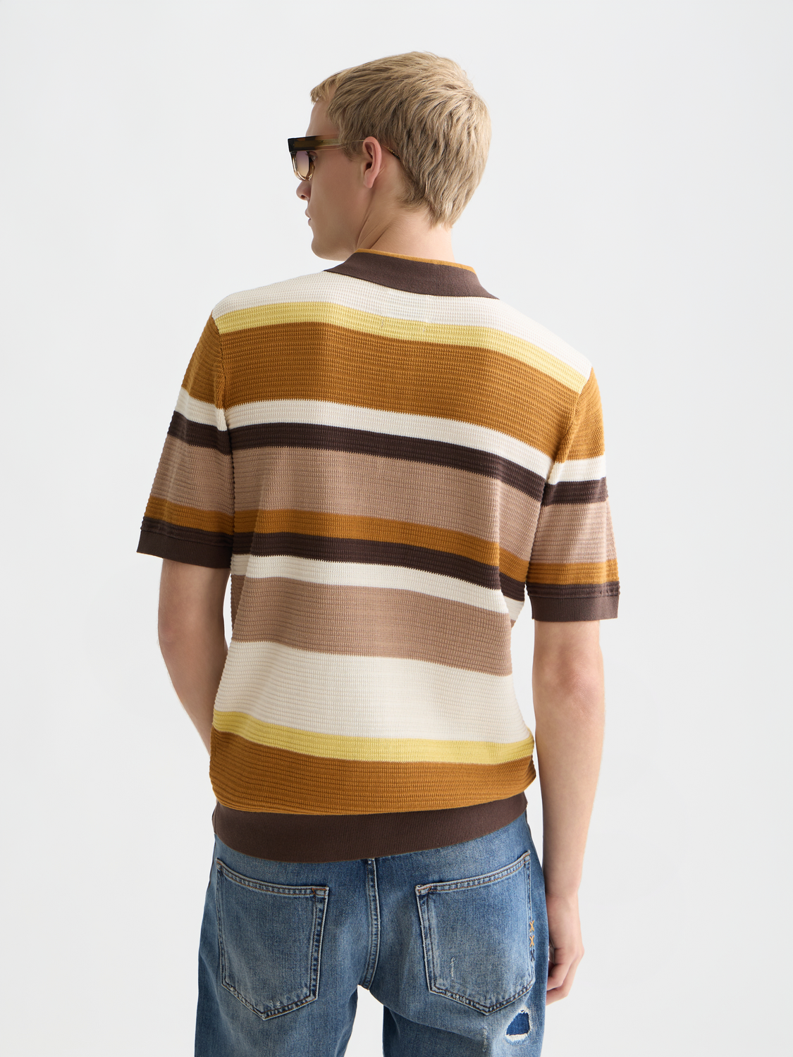 Knitted striped polo shirt by Scotch & Soda, featuring a classic collar and multicolor stripes, back view.
