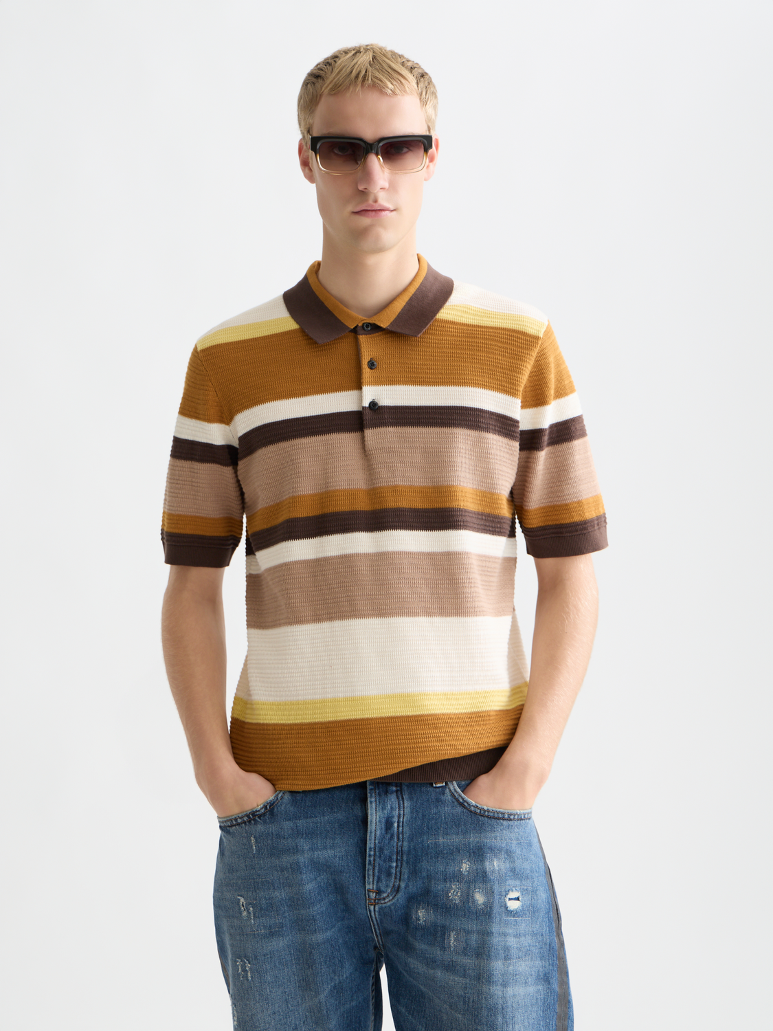 Knitted striped polo shirt by Scotch & Soda, featuring a classic collar and multicolor horizontal stripes.
