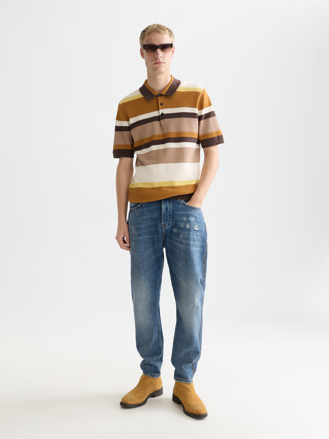 Knitted striped polo shirt from Scotch & Soda featuring a classic collar and colorful horizontal stripes.