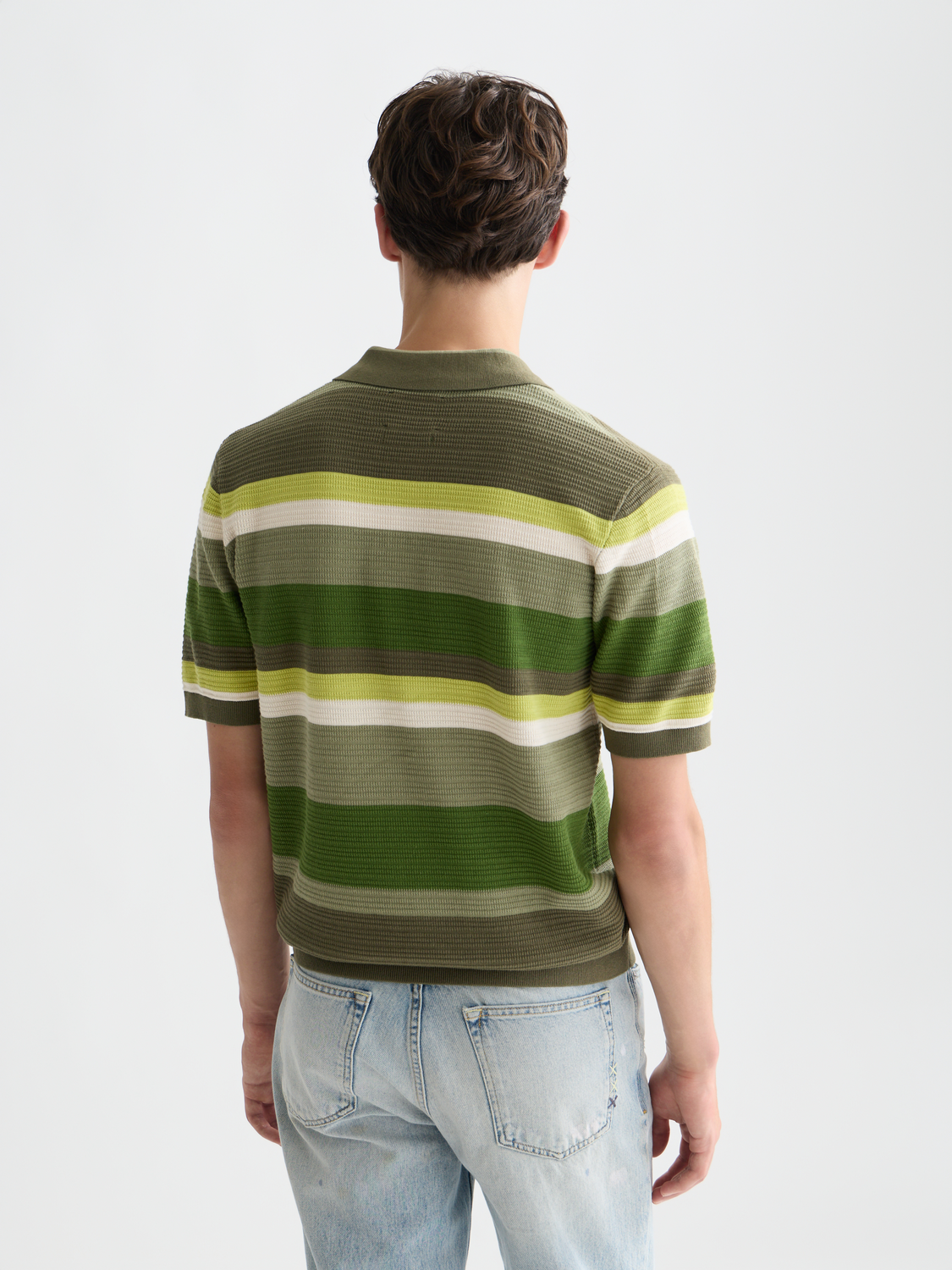 Knitted striped polo shirt by Scotch & Soda, front view showing blue, white, and red horizontal stripes and classic collar.
