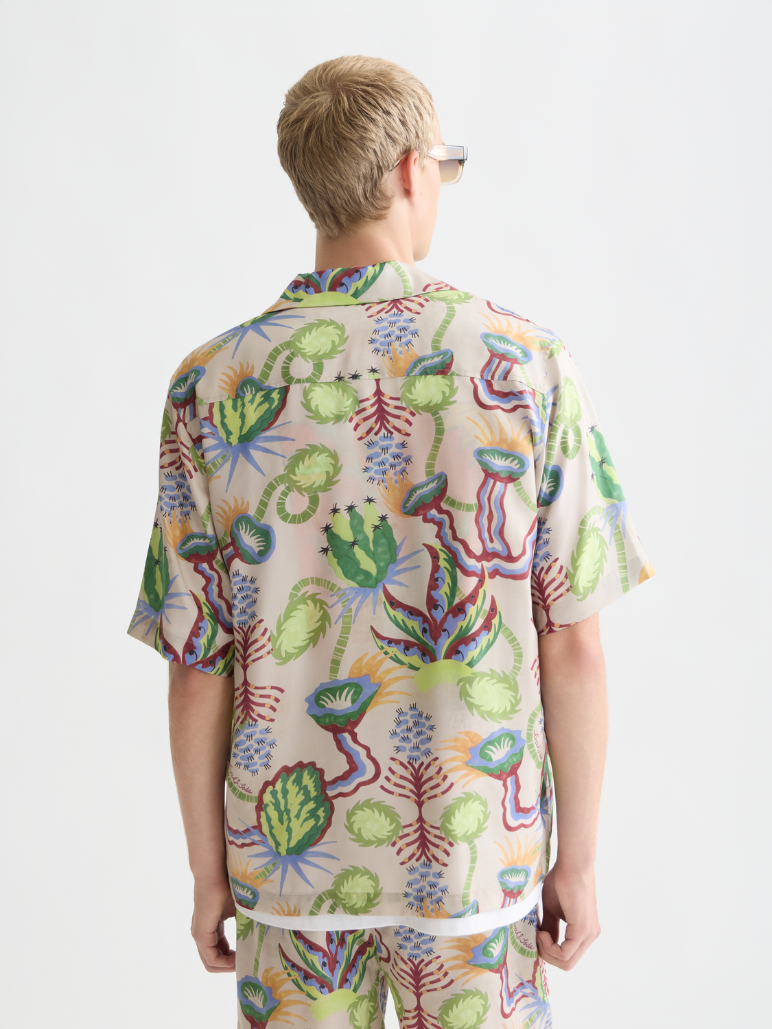 Printed Scotch & Soda short-sleeved shirt with bold pattern, shown from the back on a plain background.