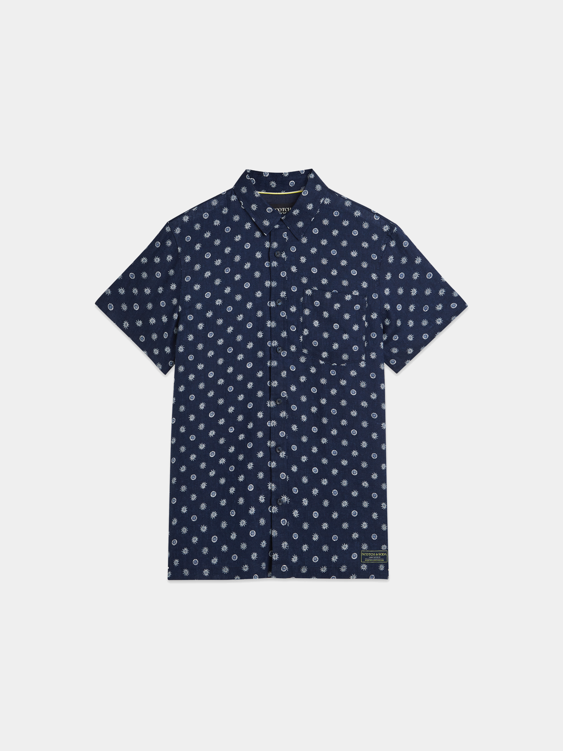 Printed short-sleeved linen shirt by Scotch & Soda, featuring a vibrant pattern and lightweight fabric suitable for warm weather.